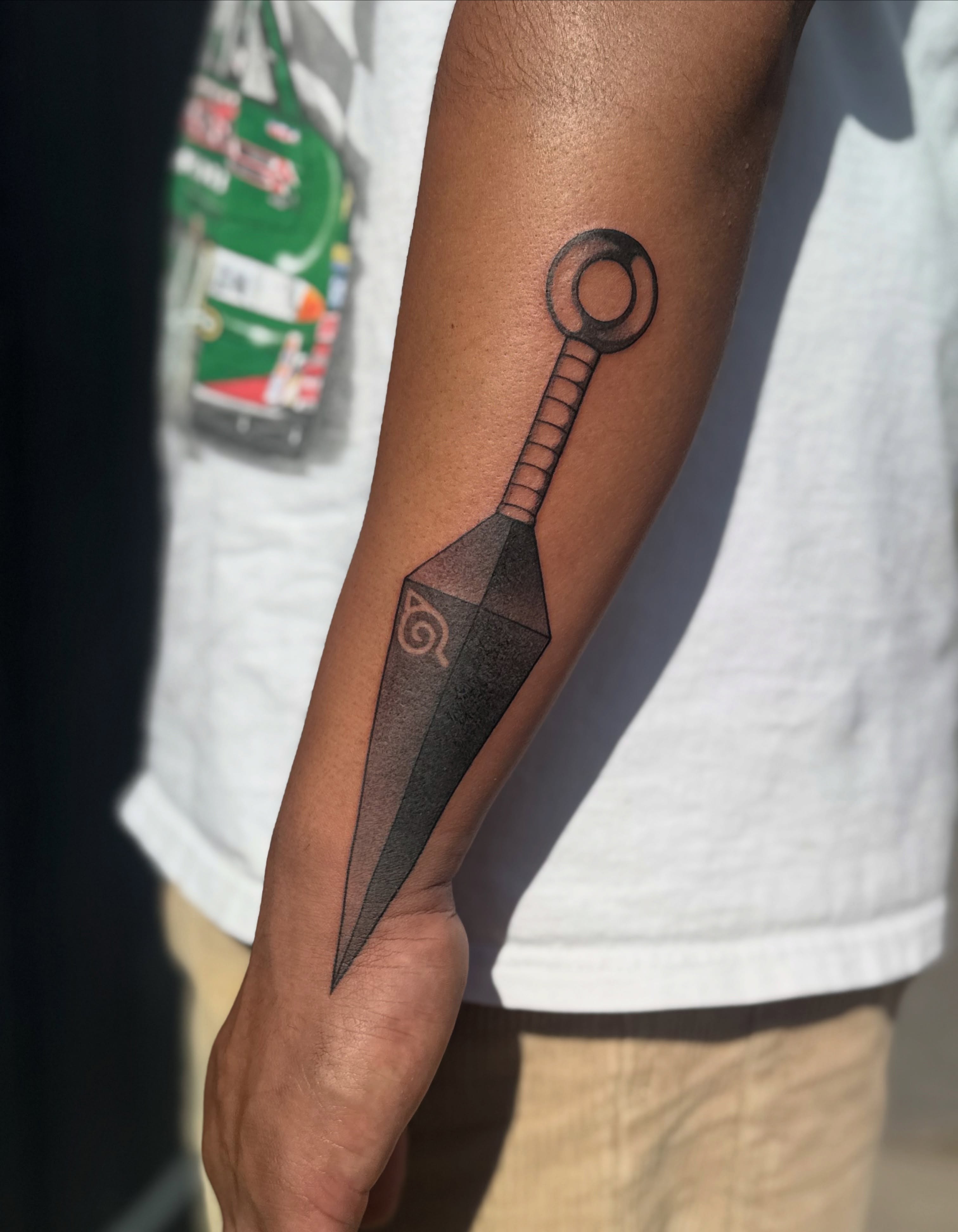 Throwing star black and grey tattoo on the forearm by Leti