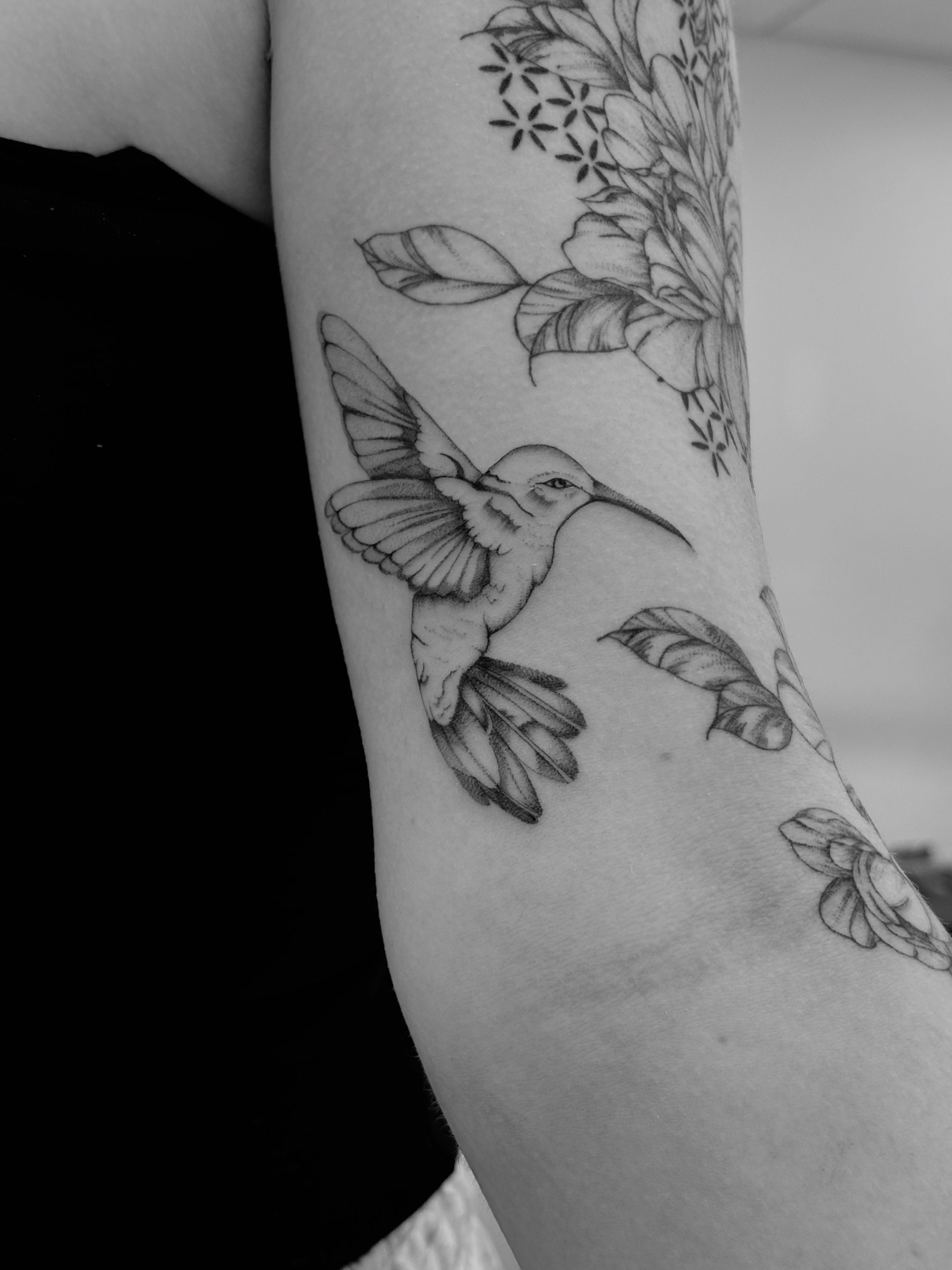 Hummingbird and floral realism tattoo on the forearm by Tayler, Tooele, Utah