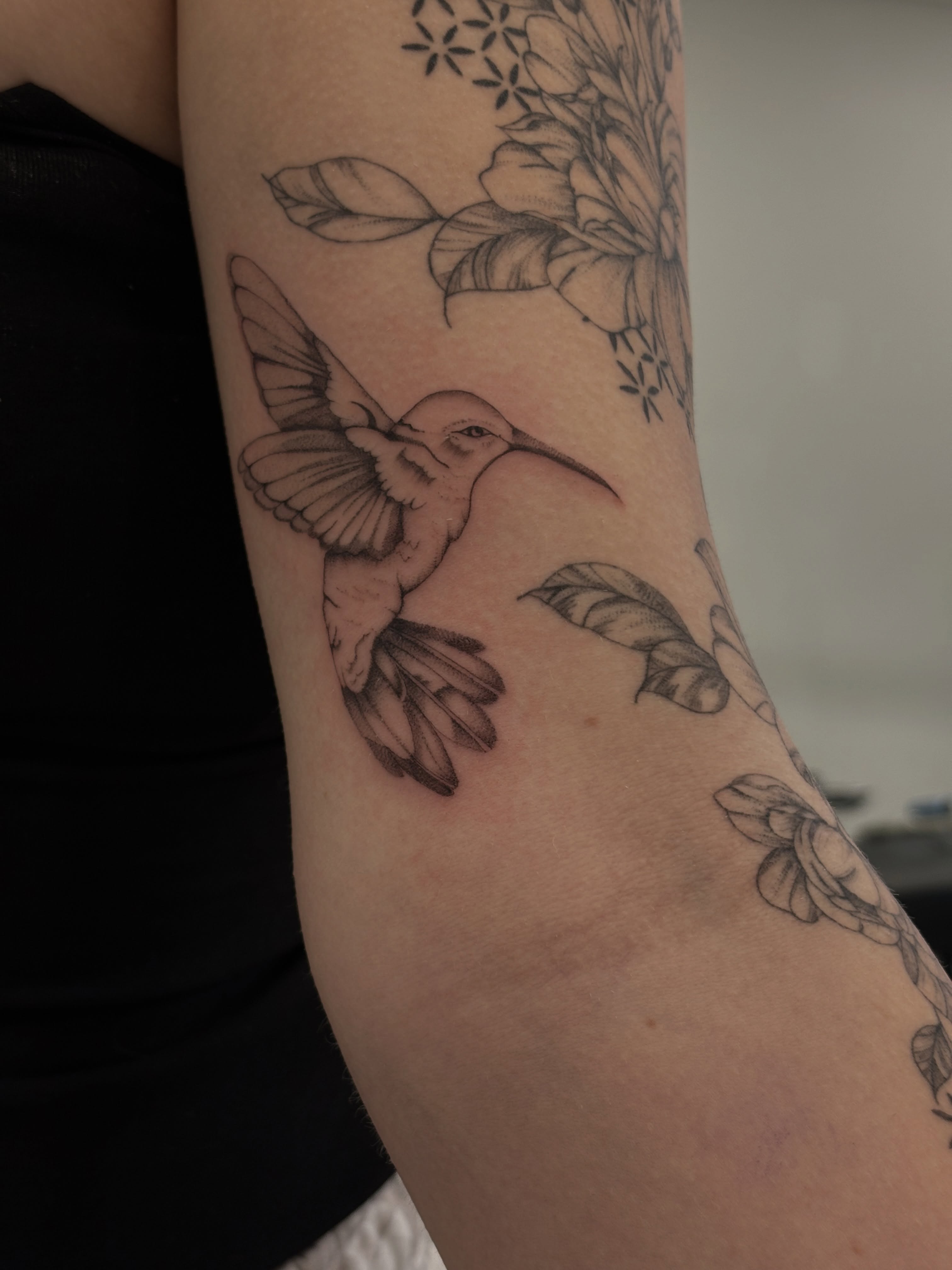 Hummingbird and flowers realism tattoo on the forearm by Tayler, Tooele, Utah