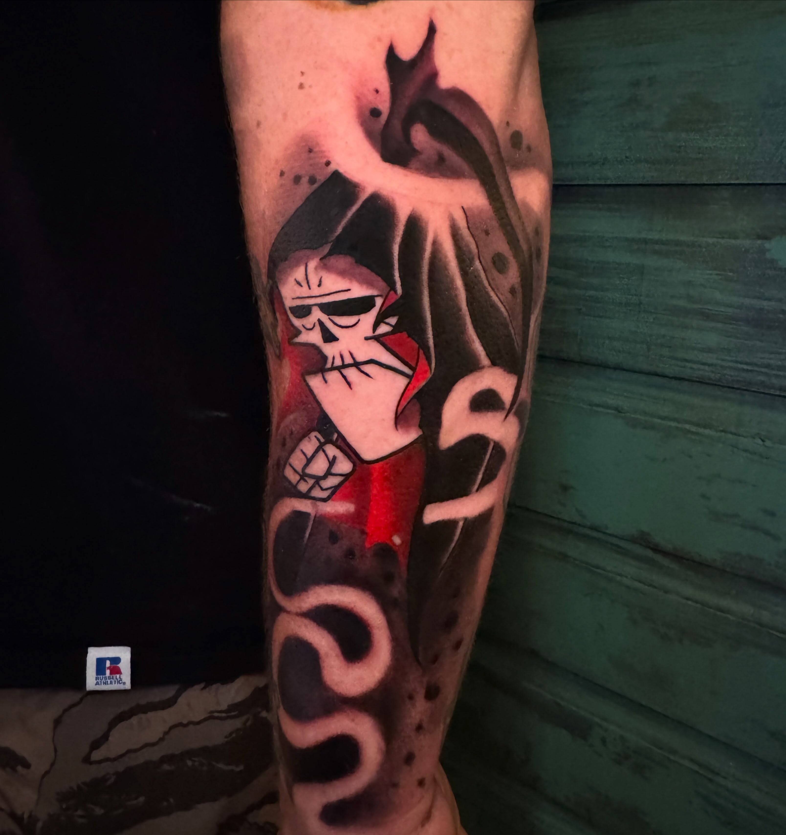 Skull with flame neo-traditional tattoo on the forearm by Brian Herrera