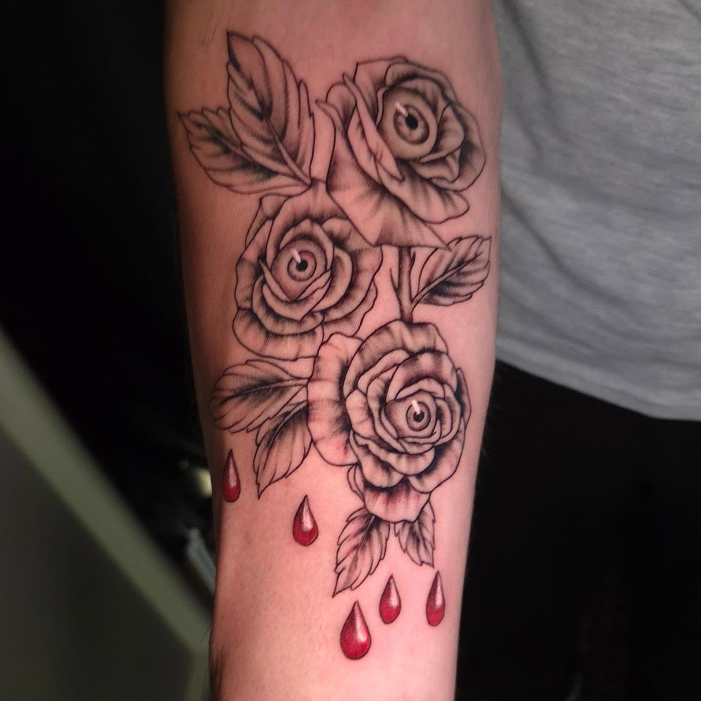 Roses with dripping blood realism tattoo on the forearm by Maya Neideck