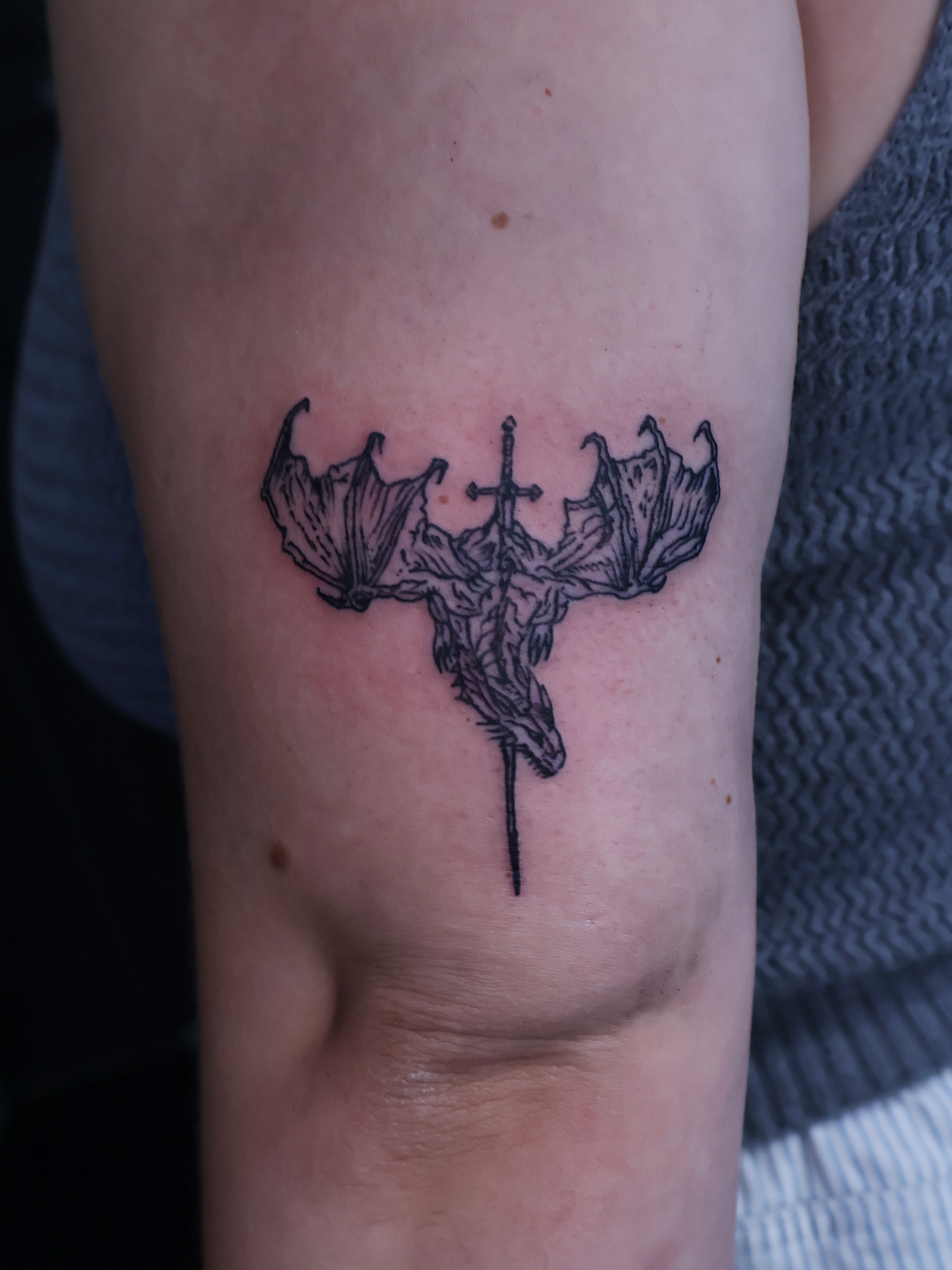 Cross with wings black and grey tattoo on the forearm by Denis Du Preez, East Williamsburg, Brooklyn