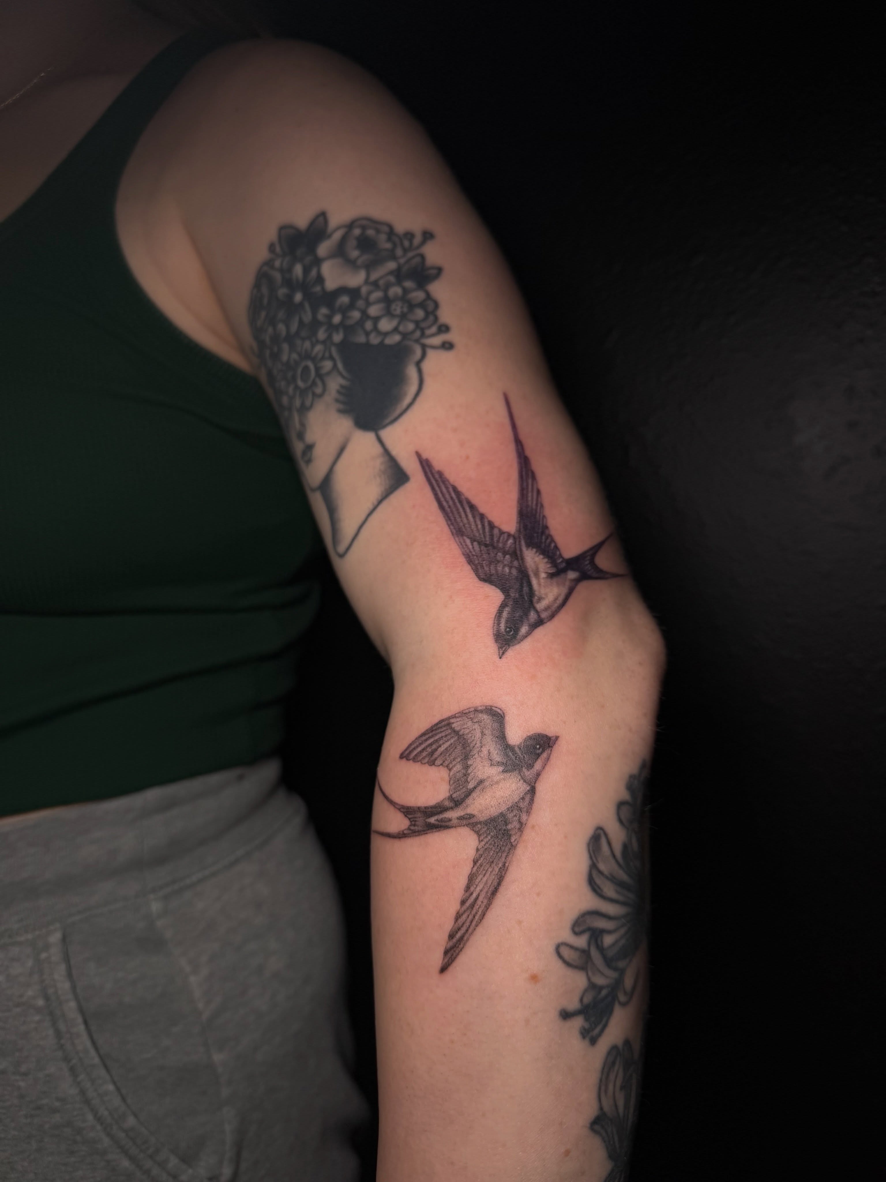 Swallows and floral dotwork tattoo on the forearm by Ink Darling, Carlisle, Iowa
