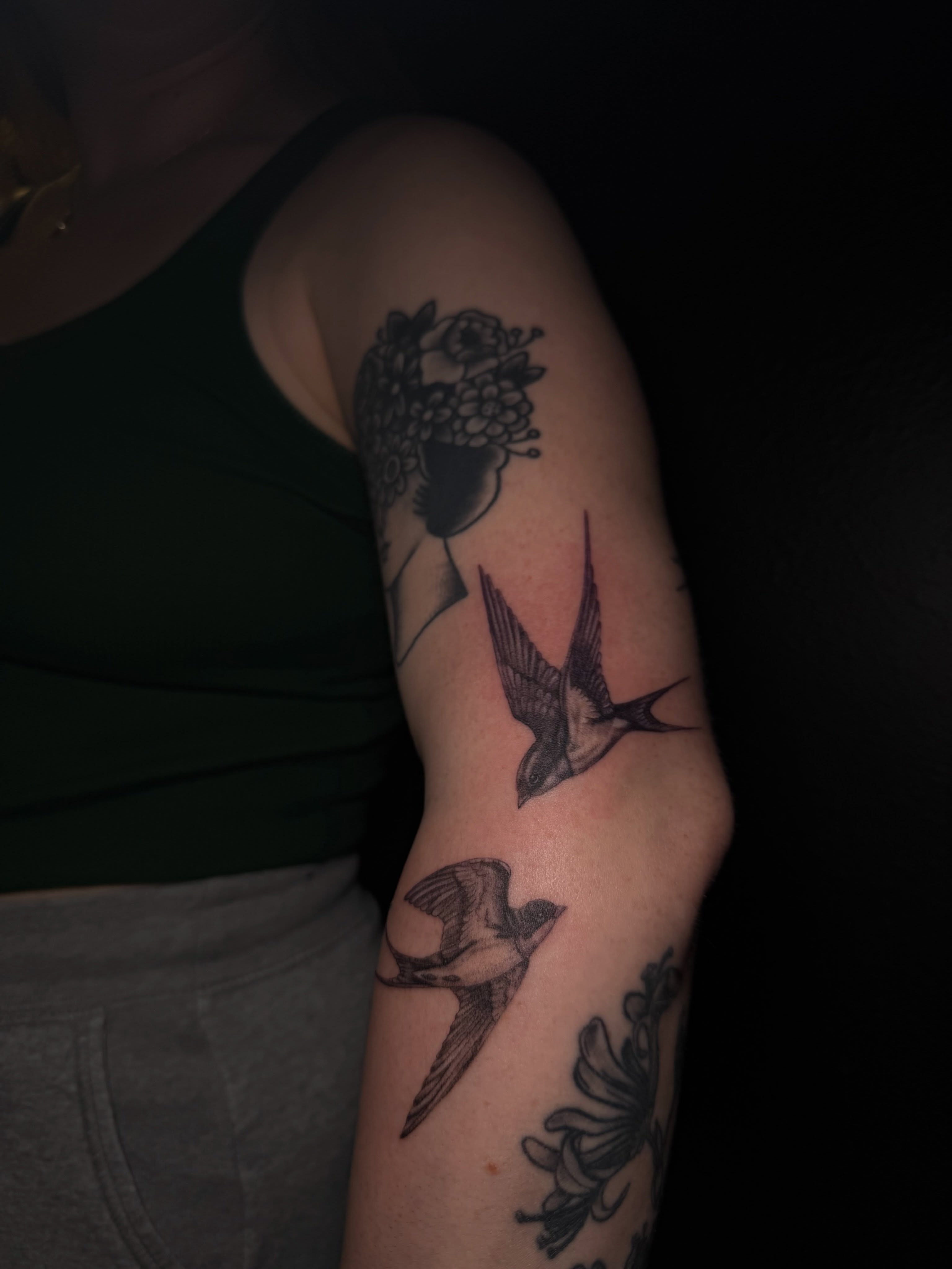Swallows and flowers black and grey tattoo on the forearm by Ink Darling, Carlisle, Iowa