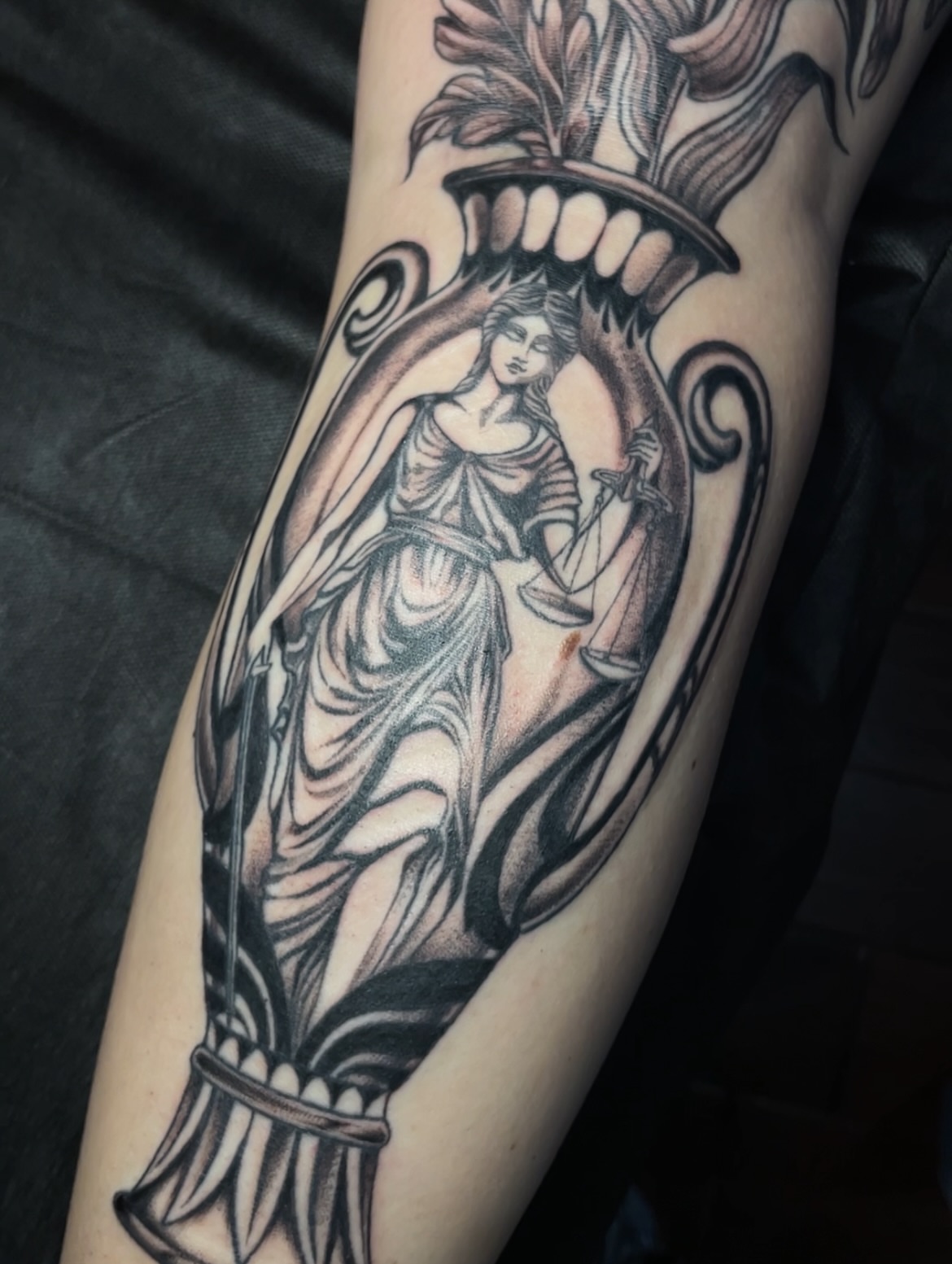 Justice statue realism tattoo on the forearm by Eryn, Portland, Oregon