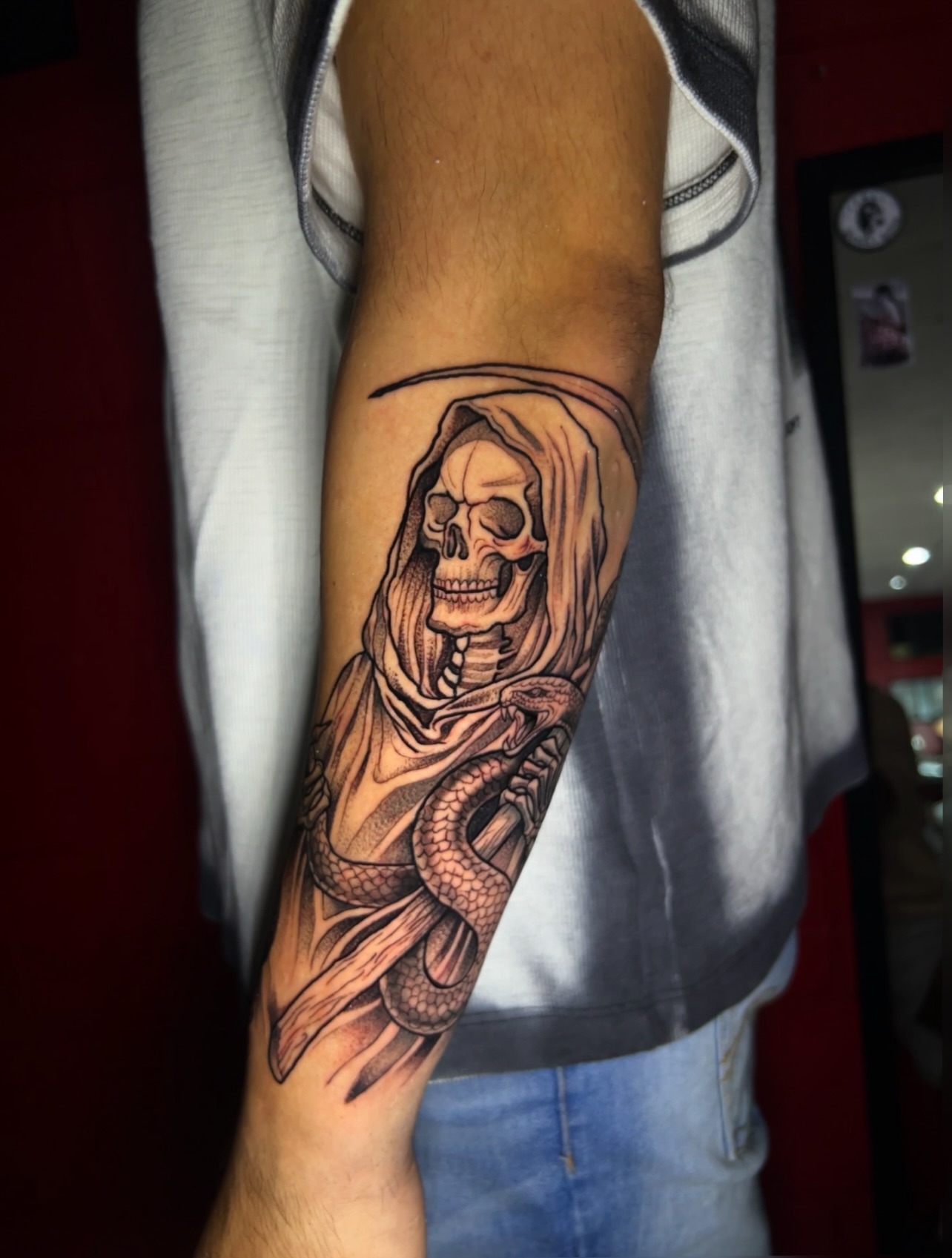 Reaper with snake realism tattoo on the forearm by El Salvador Tattoo Artist