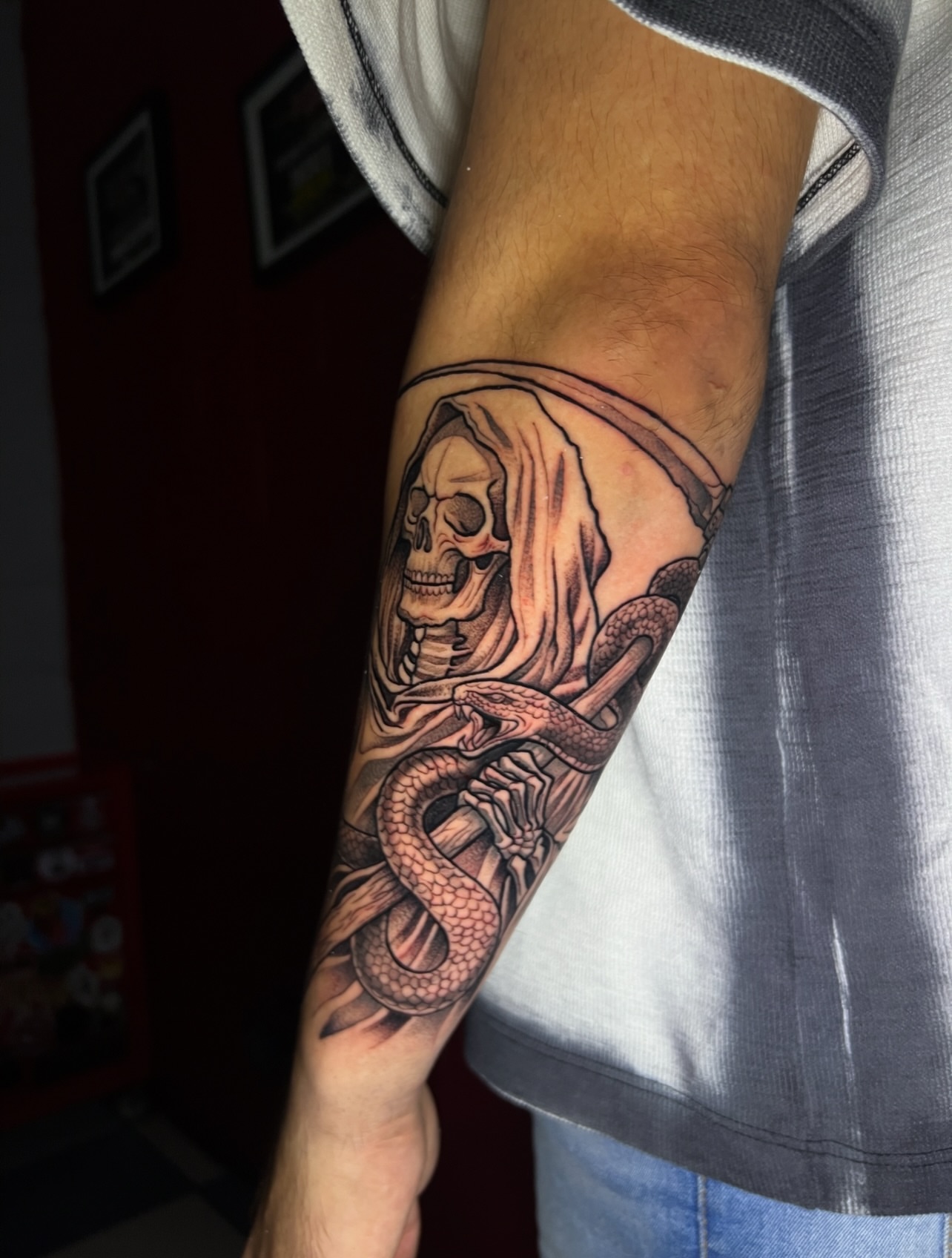 Reaper with snake realism tattoo on the forearm by El Salvador Tattoo Artist