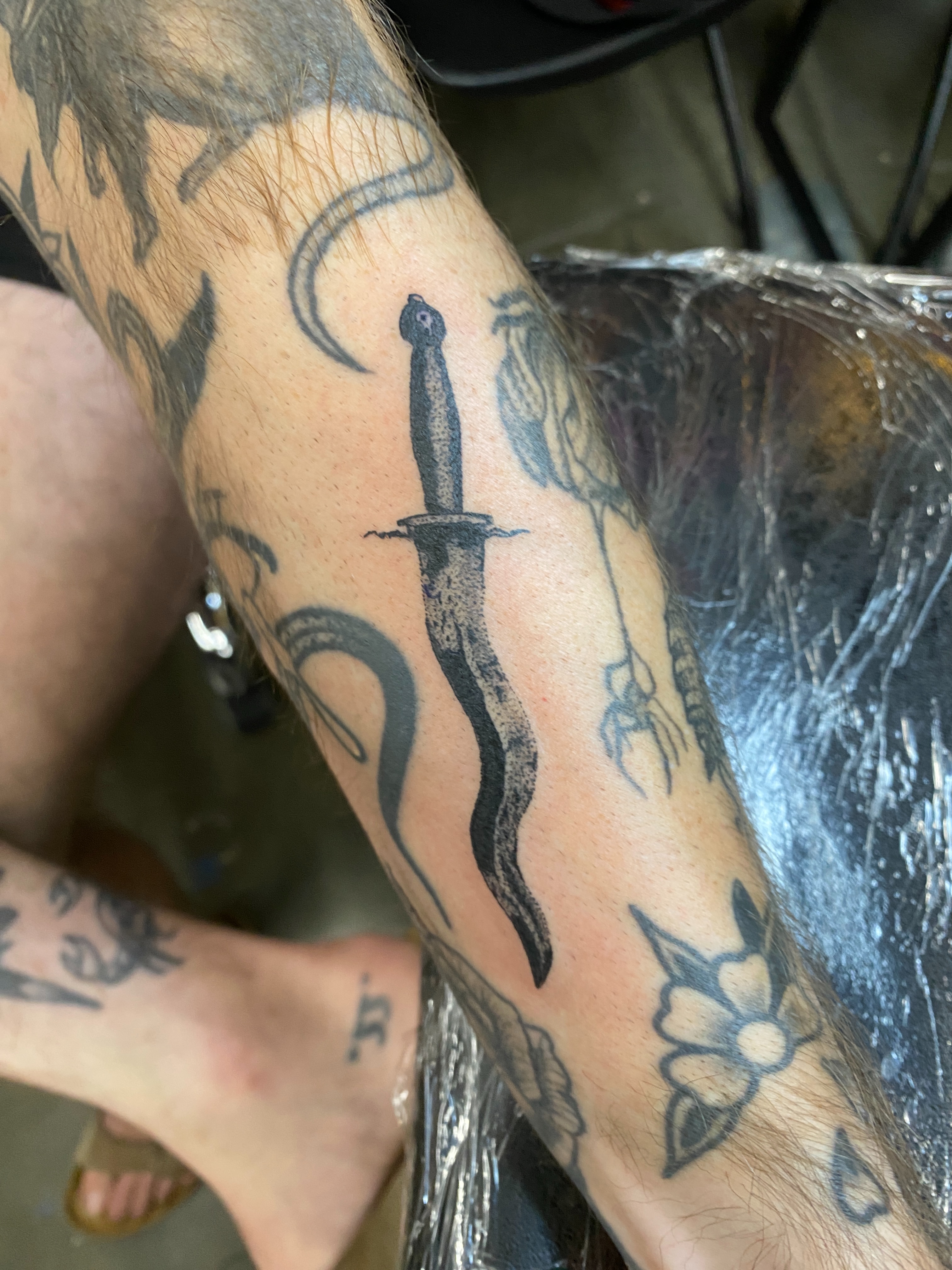 Knife and snake black and grey tattoo on the forearm by Aidan Leery, Portland, Oregon