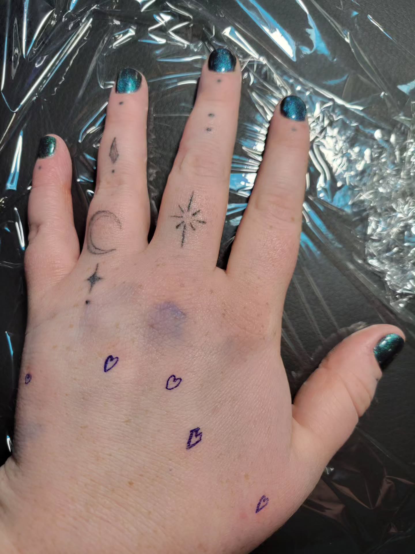 Small symbols dotwork tattoo on the hand by Bee