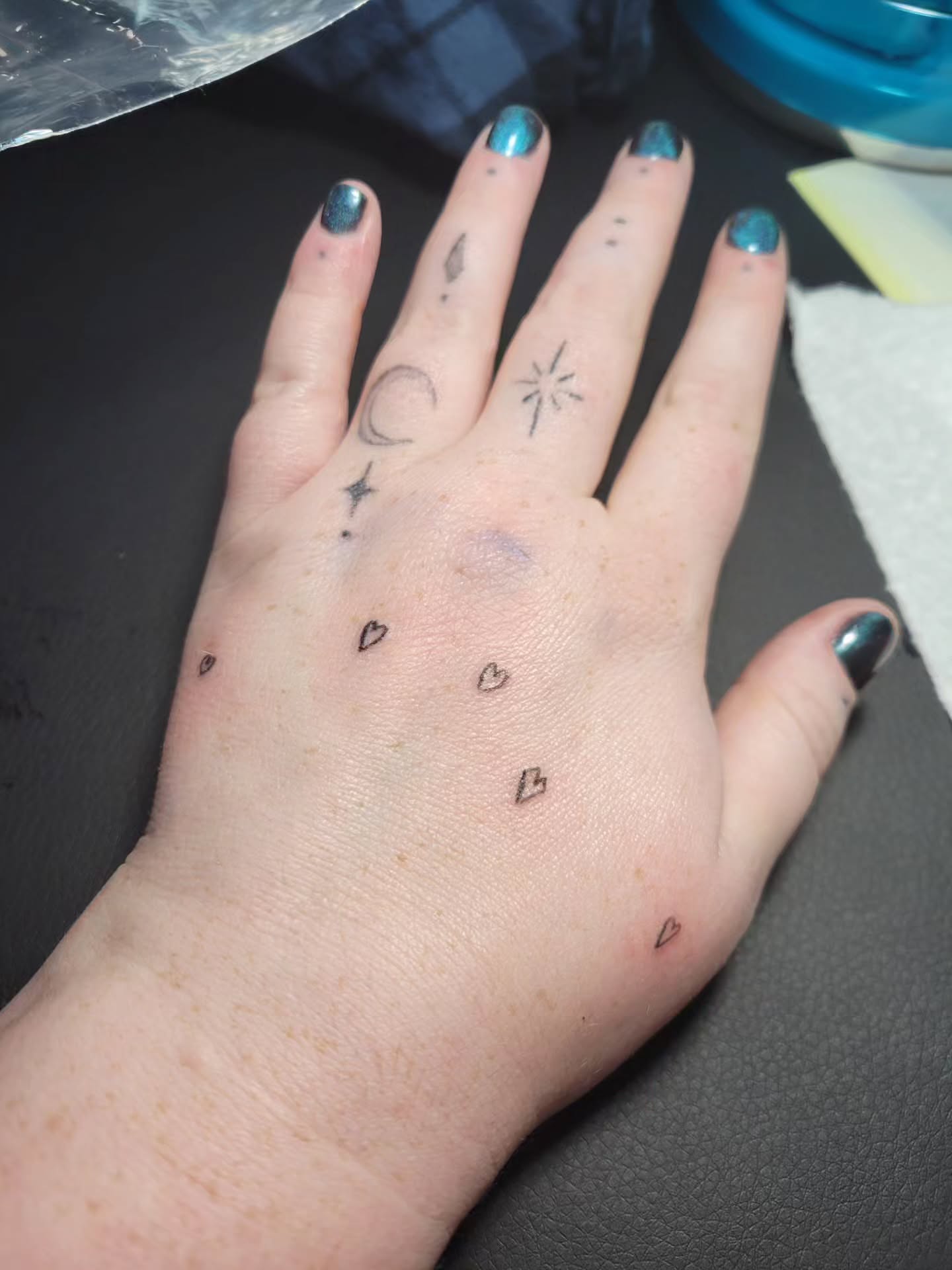 Small motifs dotwork tattoo on the hand by Bee