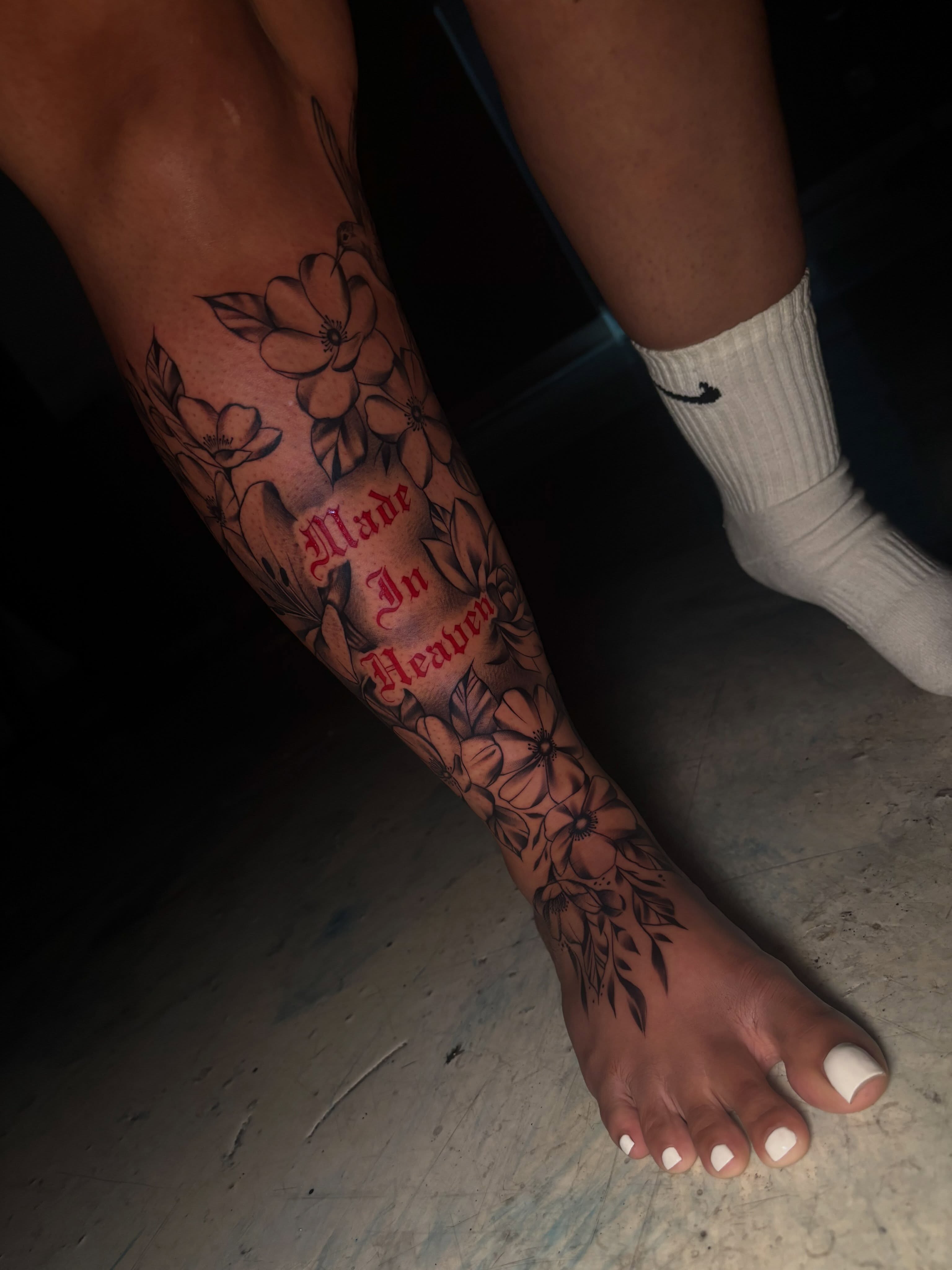Flowers and lettering black and grey tattoo on the calf by Jay Daartist