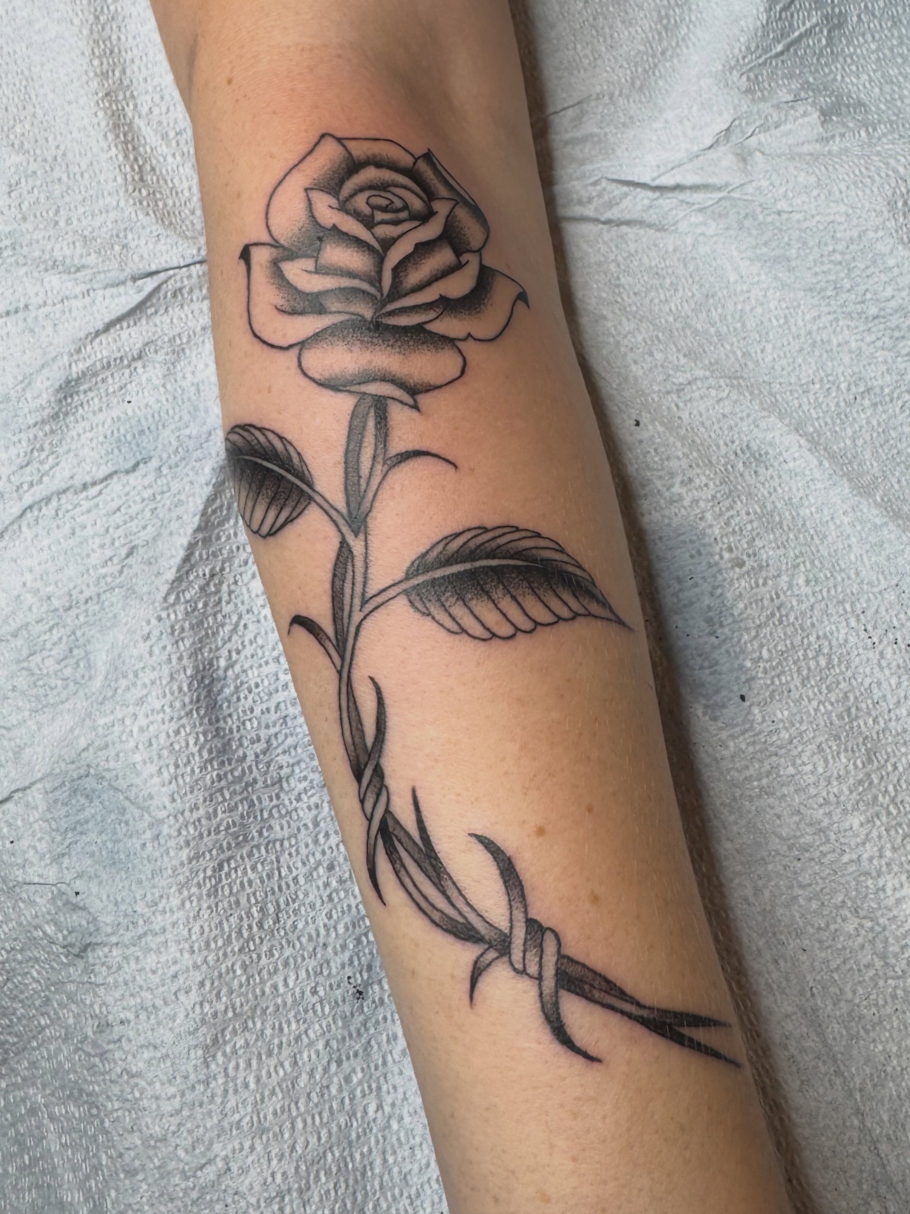 Rose and barbed wire black and grey tattoo on the forearm by Cam TallBoy SLC Tattoo Artist, Salt Lake City, Utah