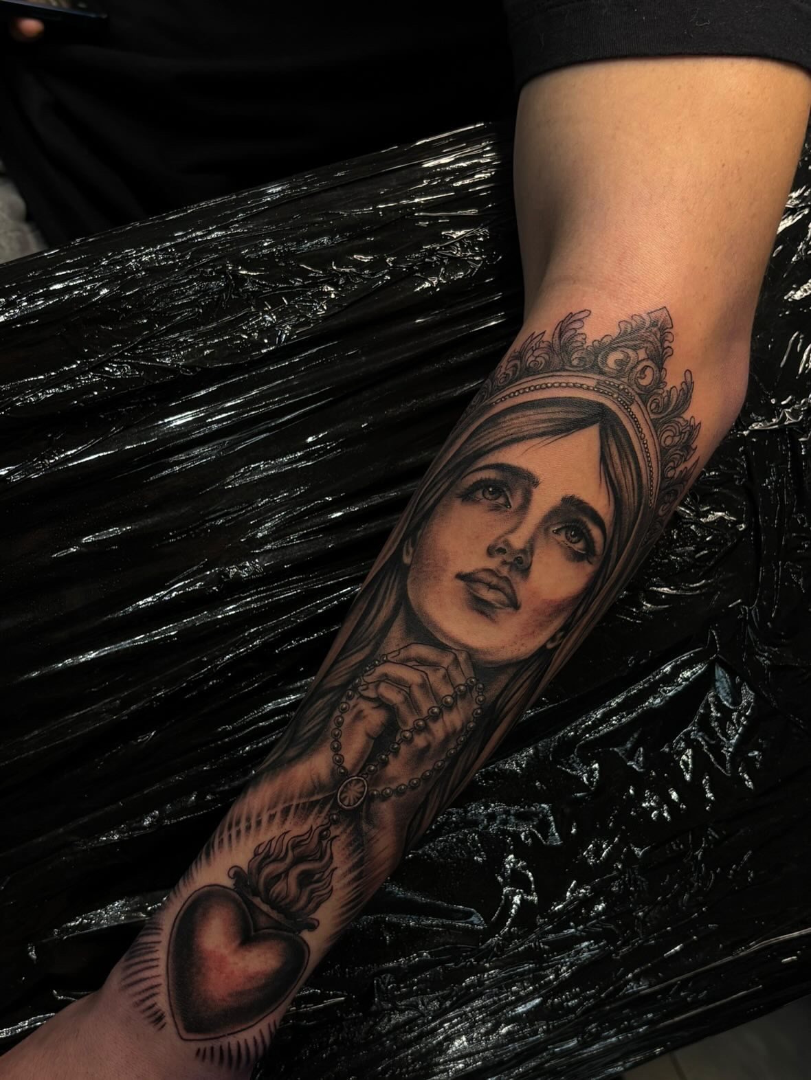 Religious figure realism tattoo on the forearm by Kevin