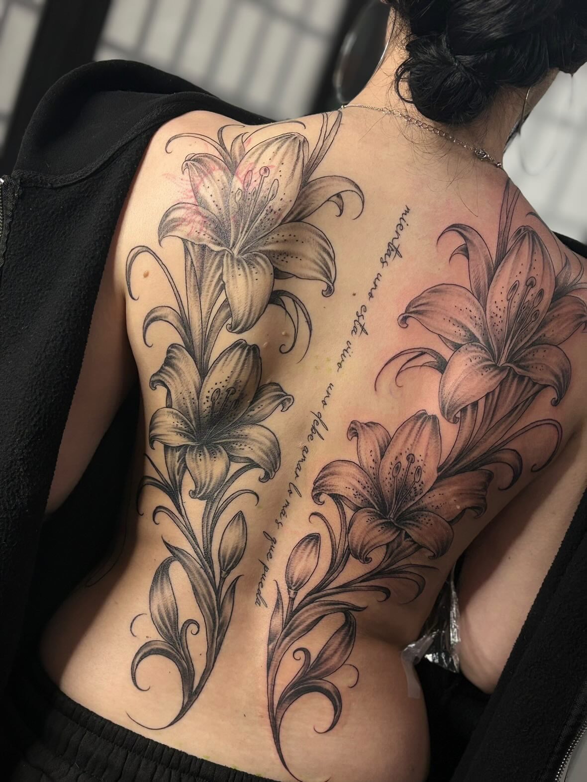 Lilies black and grey tattoo on the back by Kevin