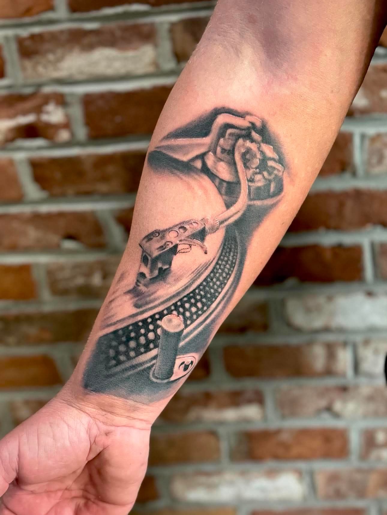 Record player dotwork tattoo on the forearm by Kyle J. Bishop