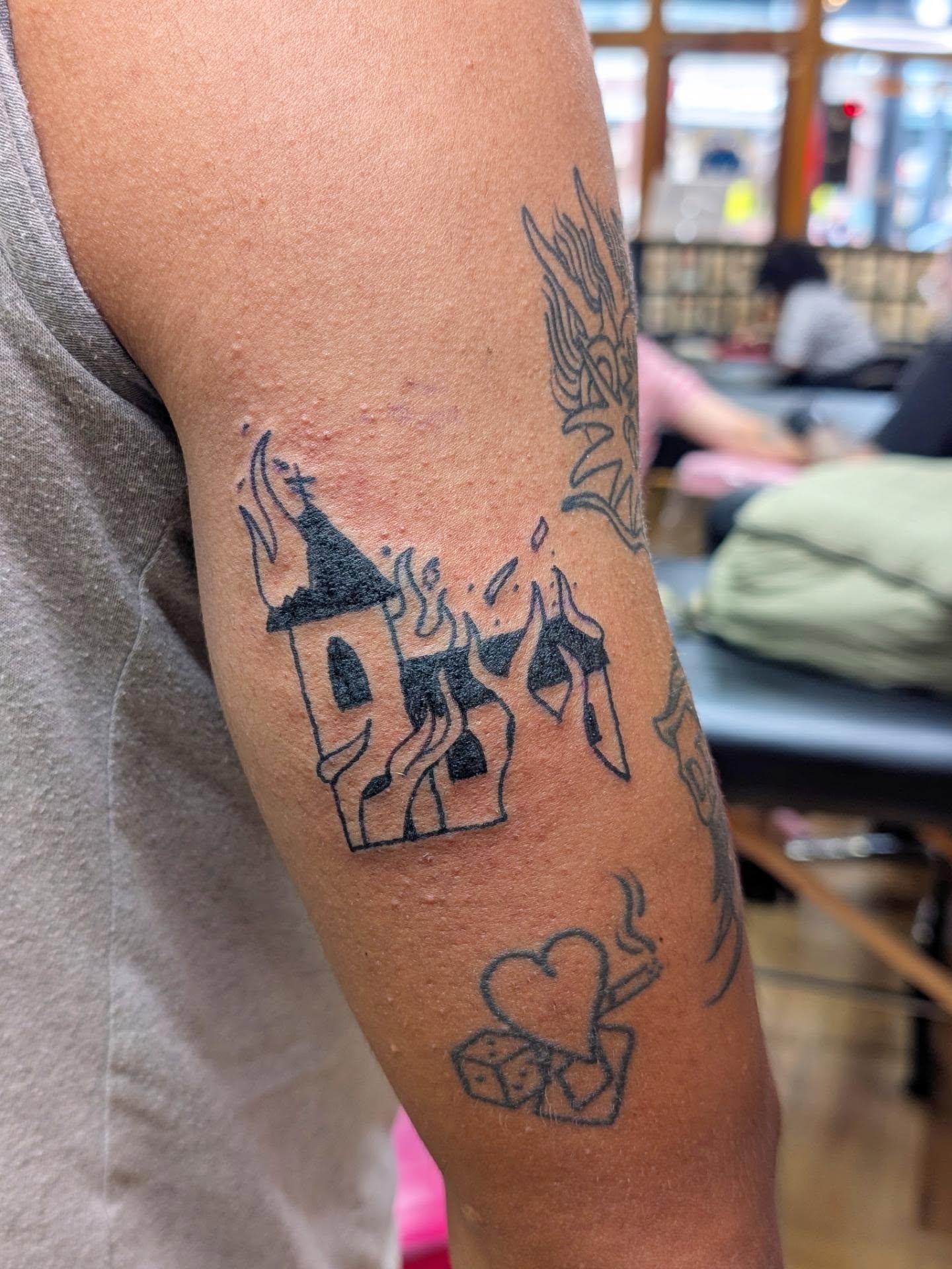 Burning castle black and grey tattoo on the forearm by Jon Sedor