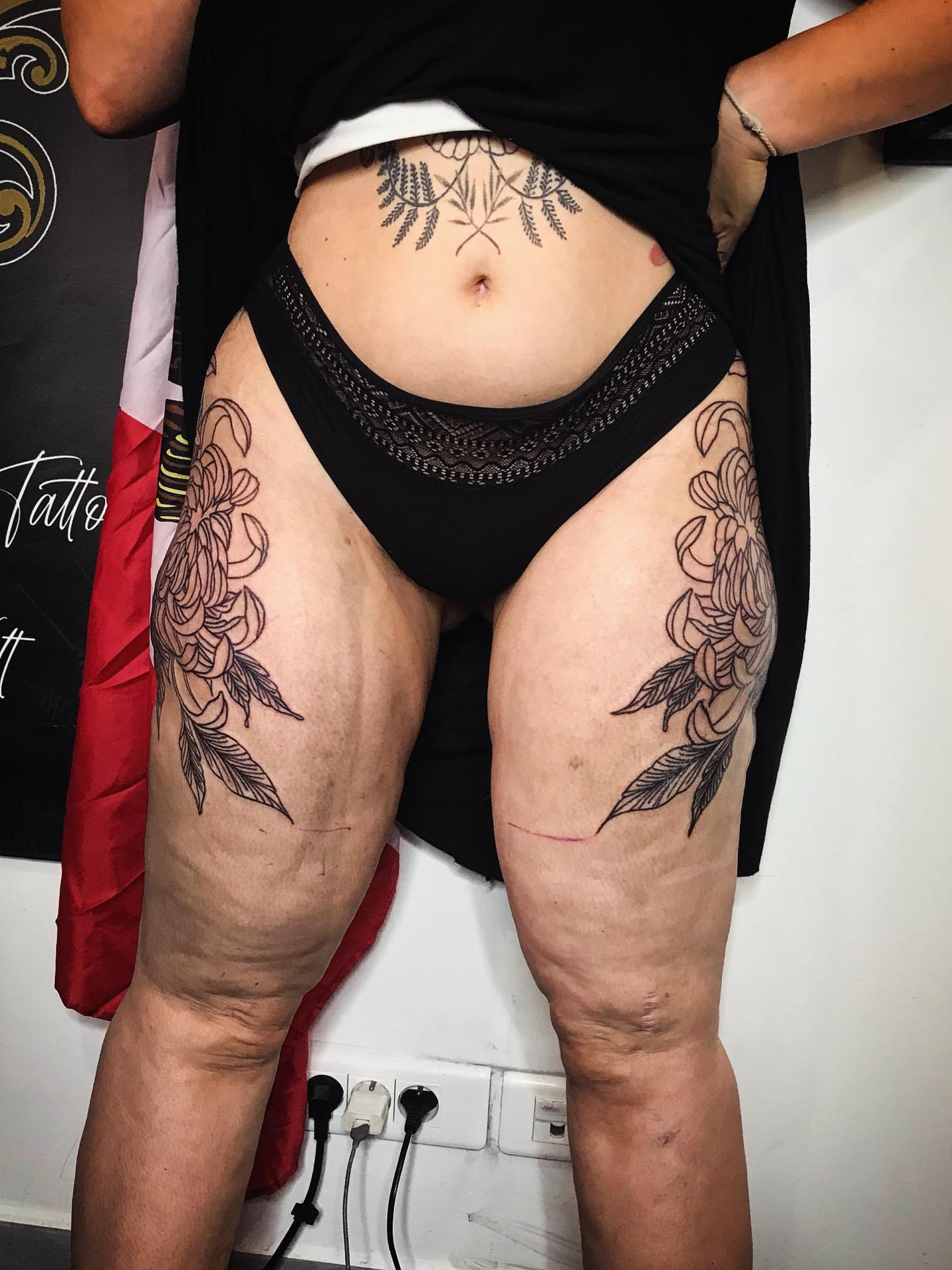Floral black and grey tattoo on the thigh by Moss Quito Tattoo