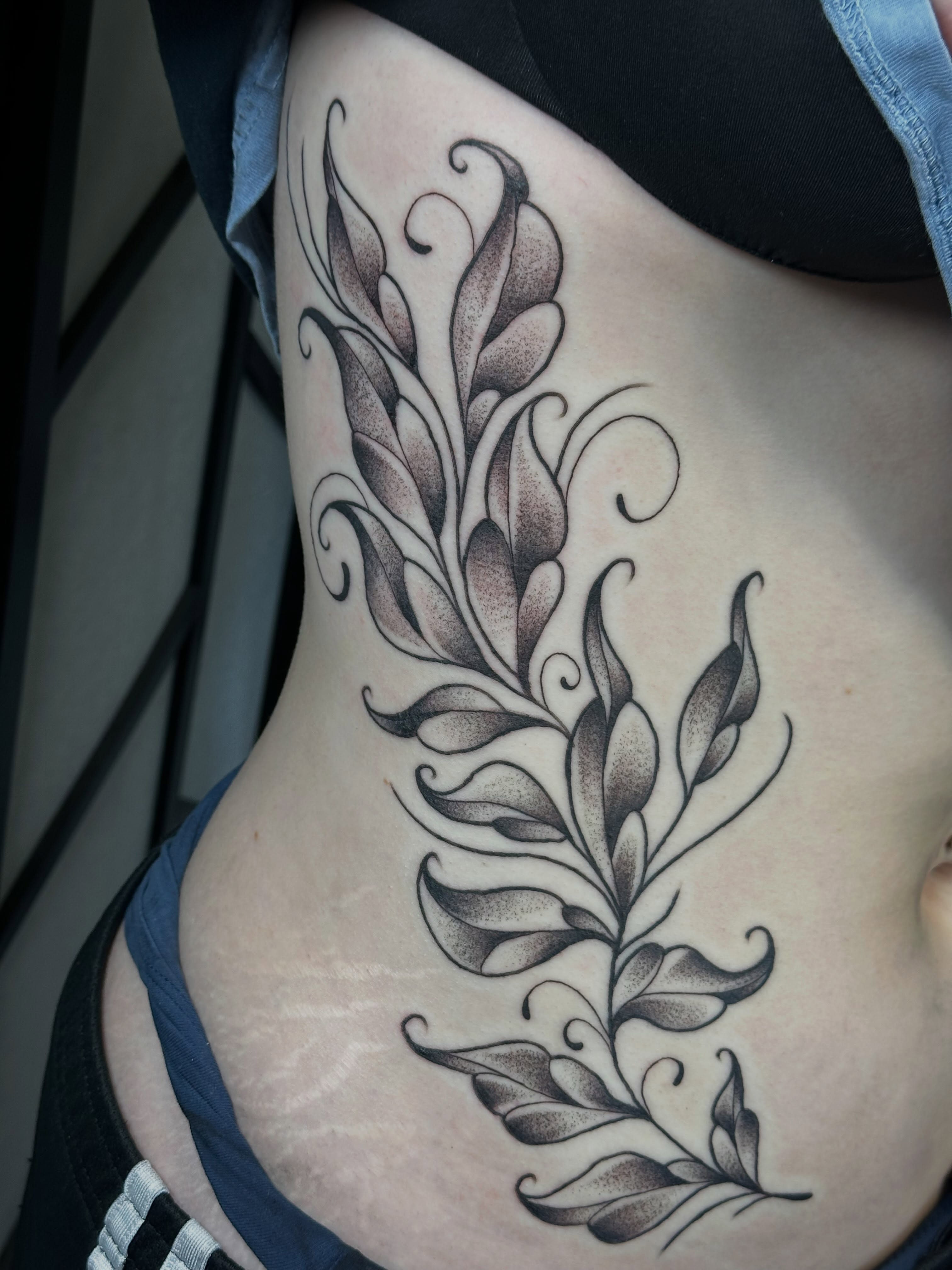 Feather dotwork tattoo on the ribs by Elisha B🦷