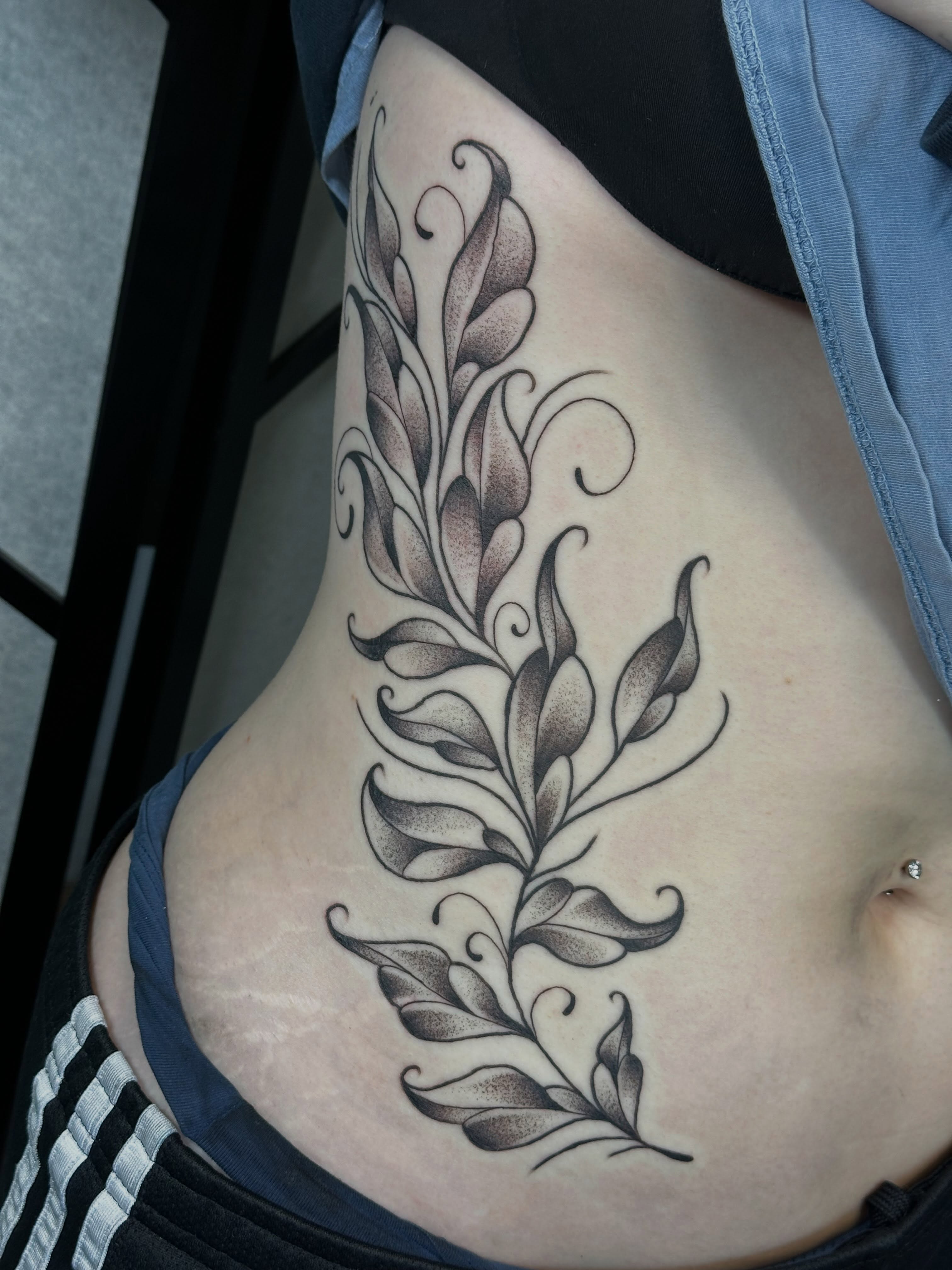 Floral vine black and grey tattoo on the ribs by Elisha B🦷