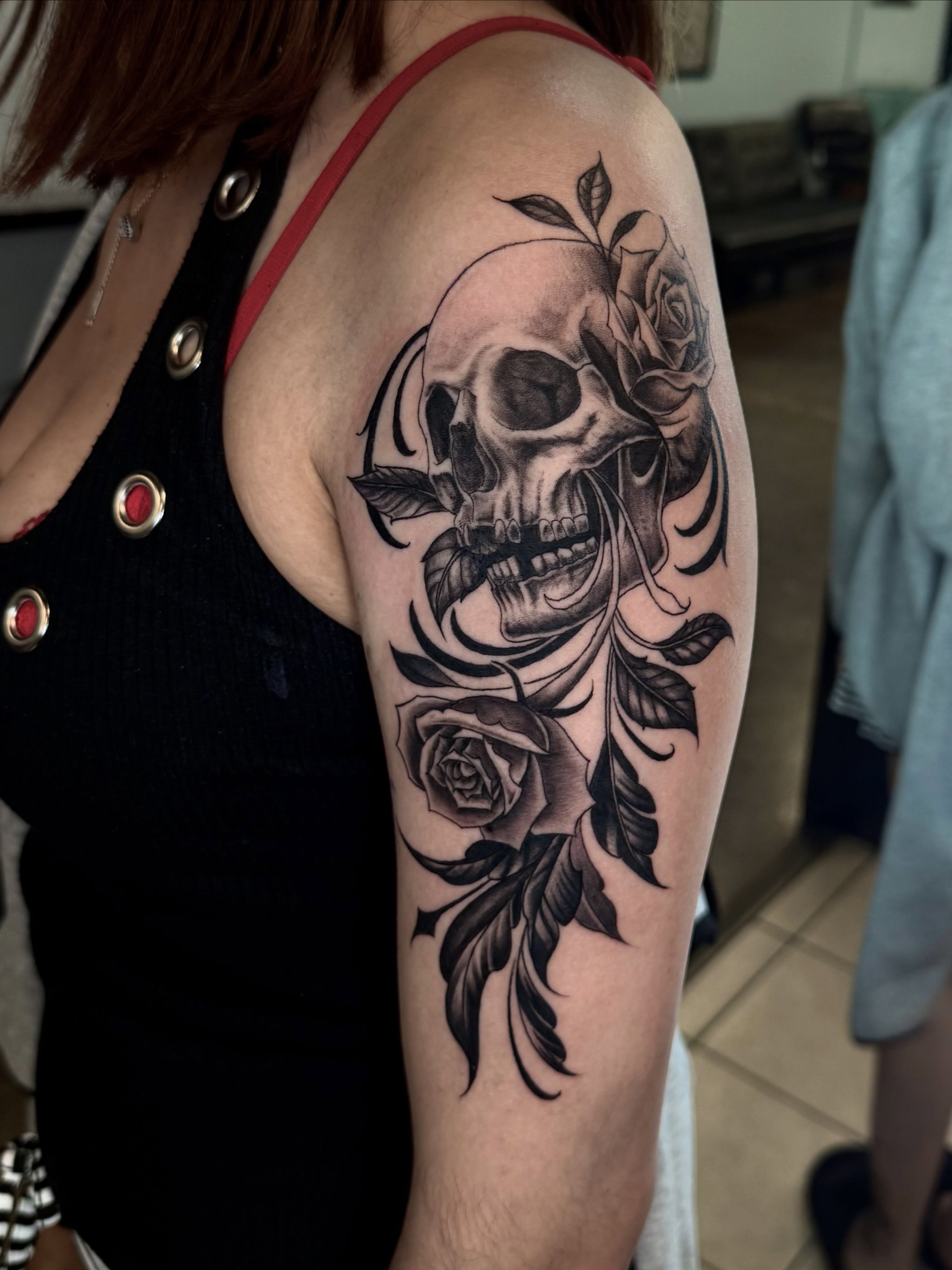 Skull and roses realism tattoo on the upper arm by Stilow Memphis Tattoo Artist, Memphis, Tennessee