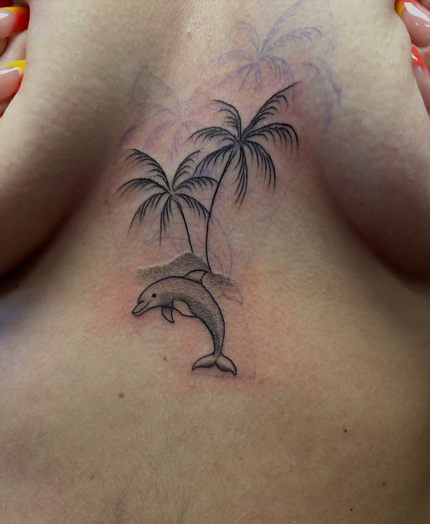 Dolphins and palm trees black and grey tattoo on the chest by Chris