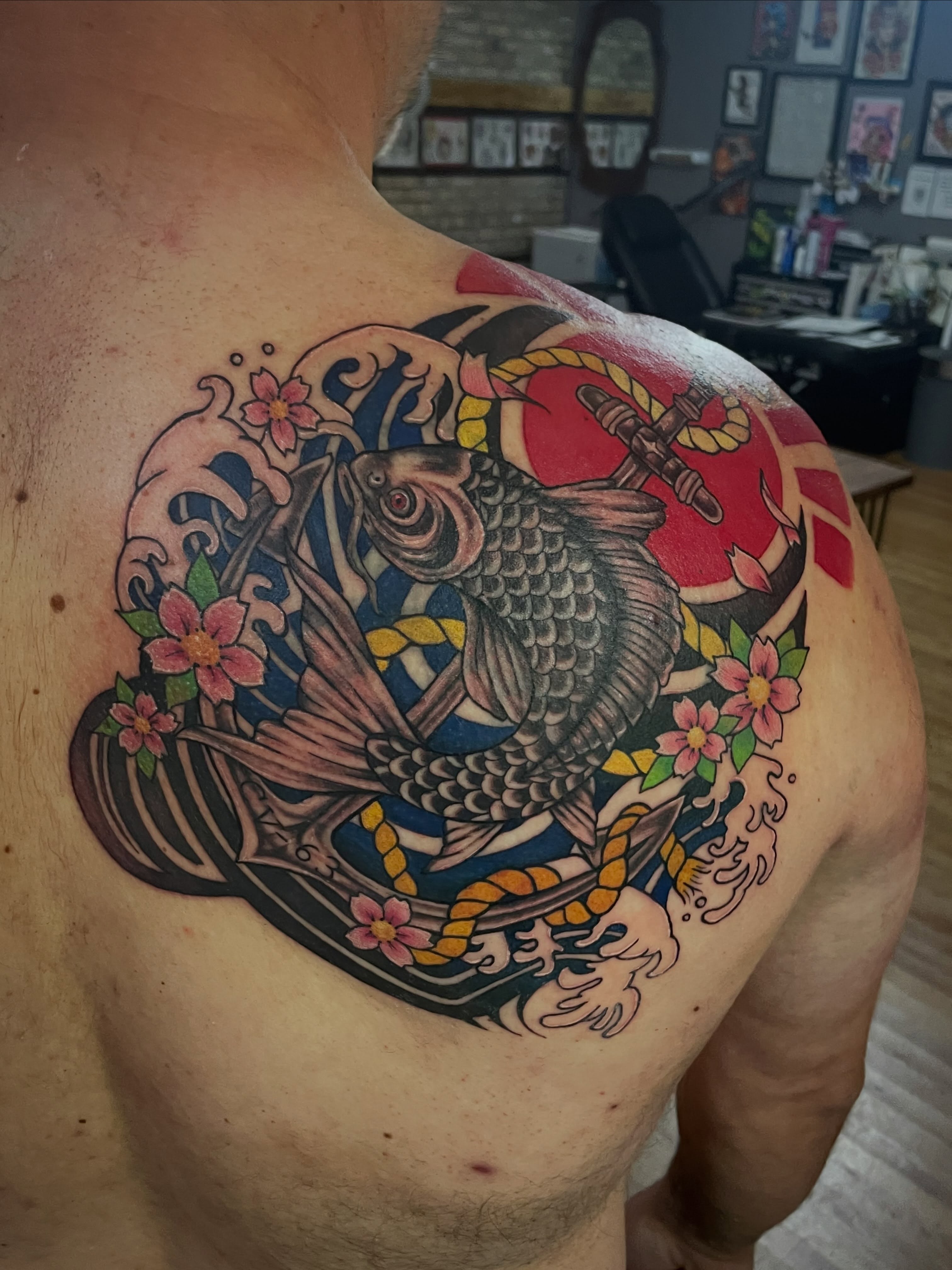 Koi fish and flowers japanese irezumi tattoo on the back by Hannah Copeskey