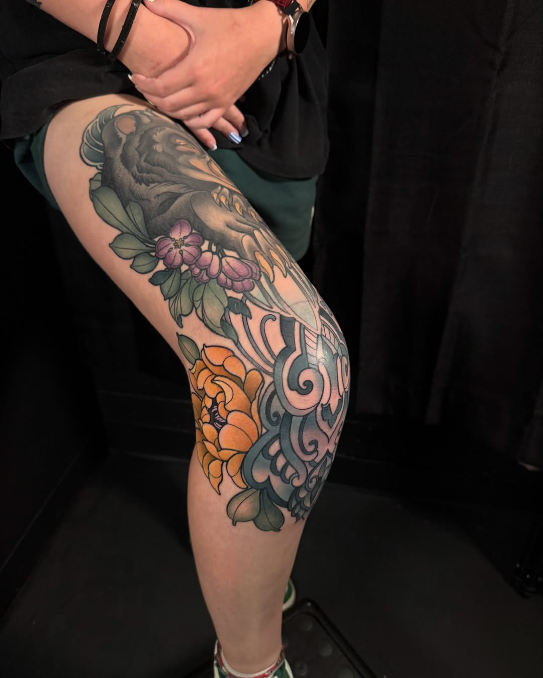 Lion and floral American traditional tattoo on the thigh by Jade Lewis