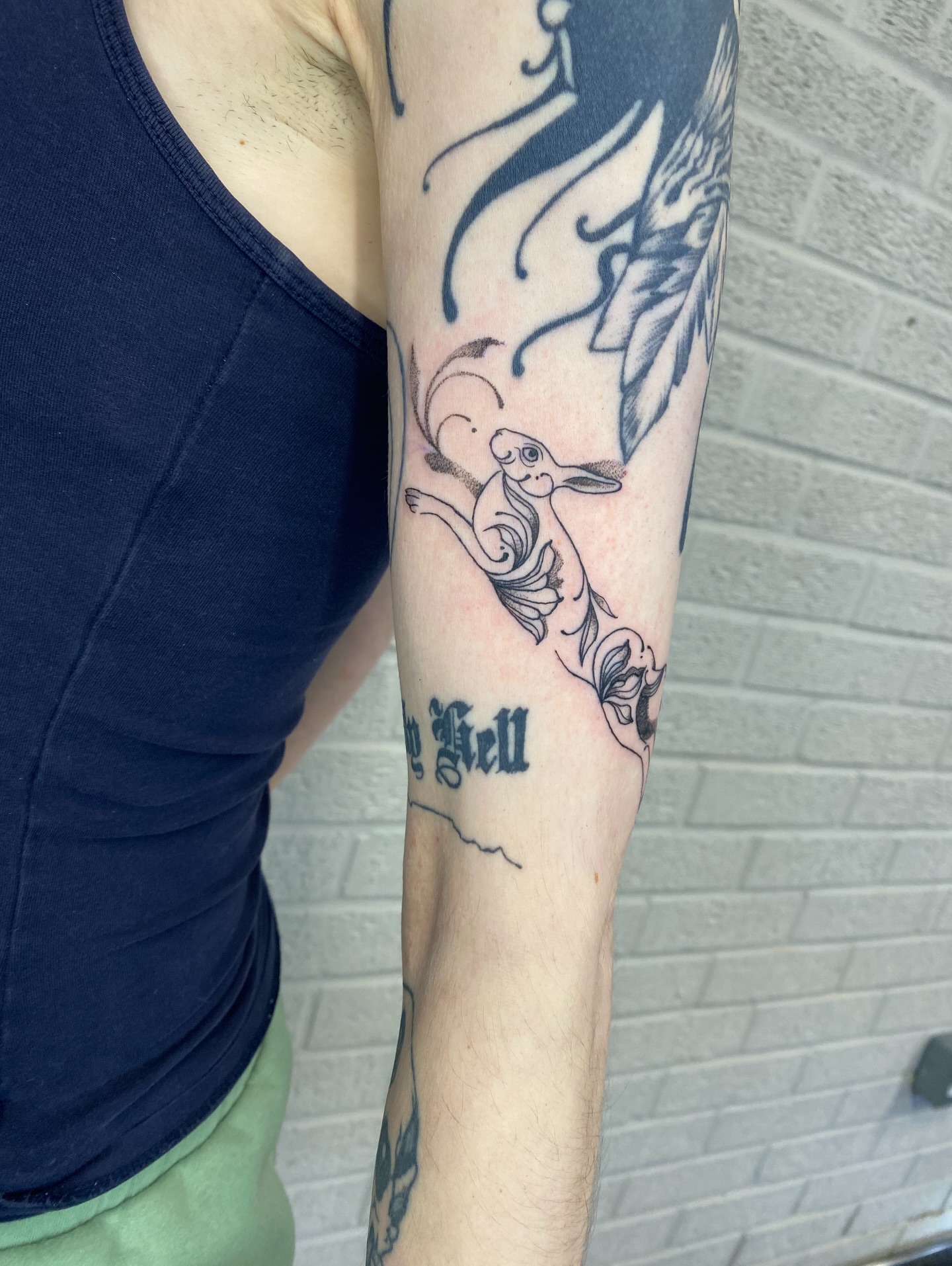 Goat and angel black and grey tattoo on the forearm by Ellena Reggiani