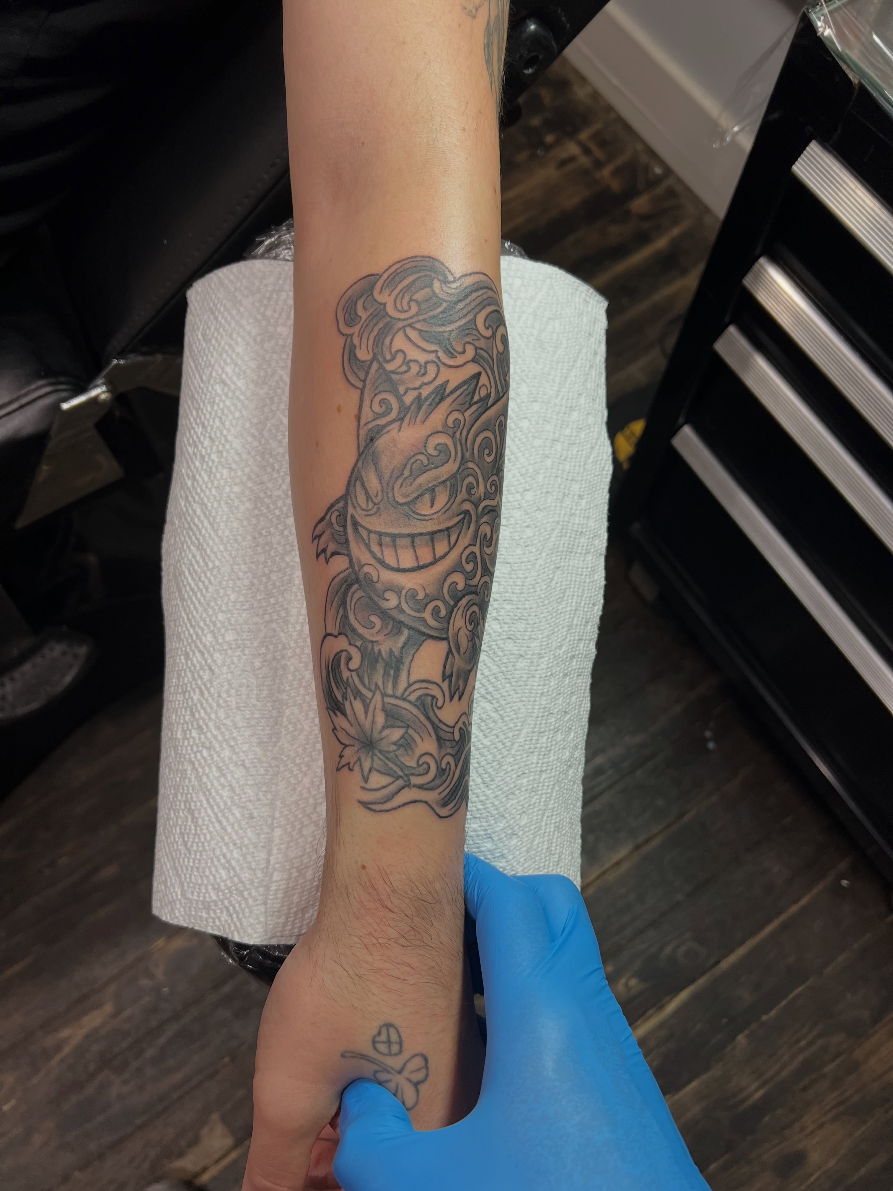 Lion black and grey tattoo on the forearm by A.W.