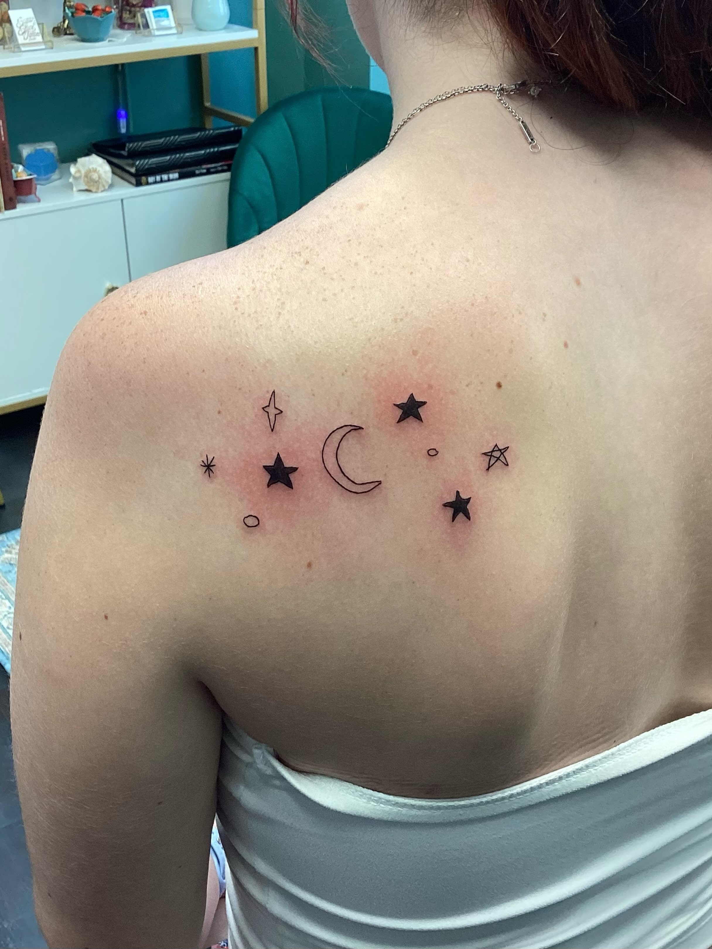 Stars and crescent moon geometric tattoo on the back by Amanda Plavan