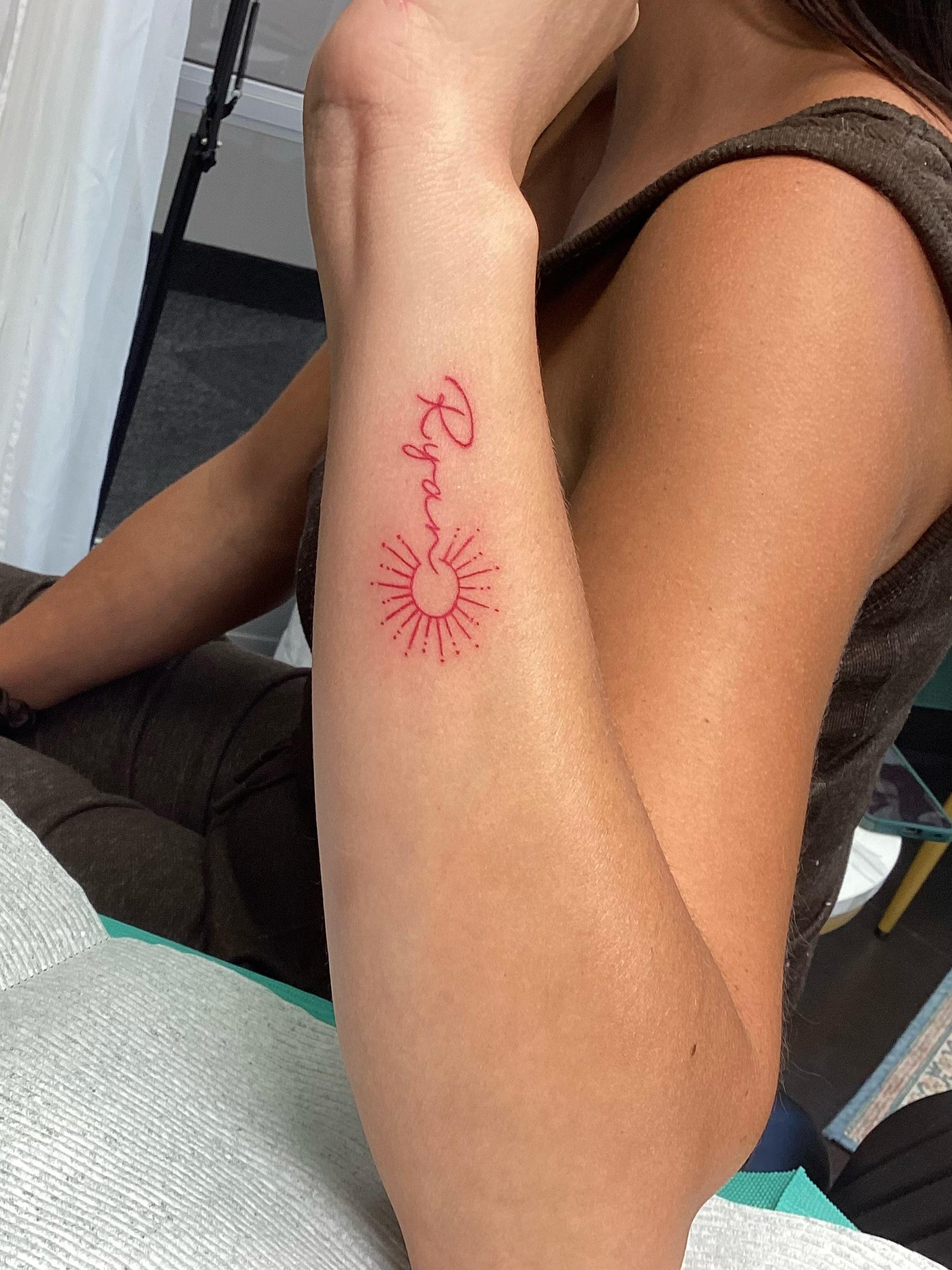 Sunburst with name dotwork tattoo on the forearm by Amanda Plavan