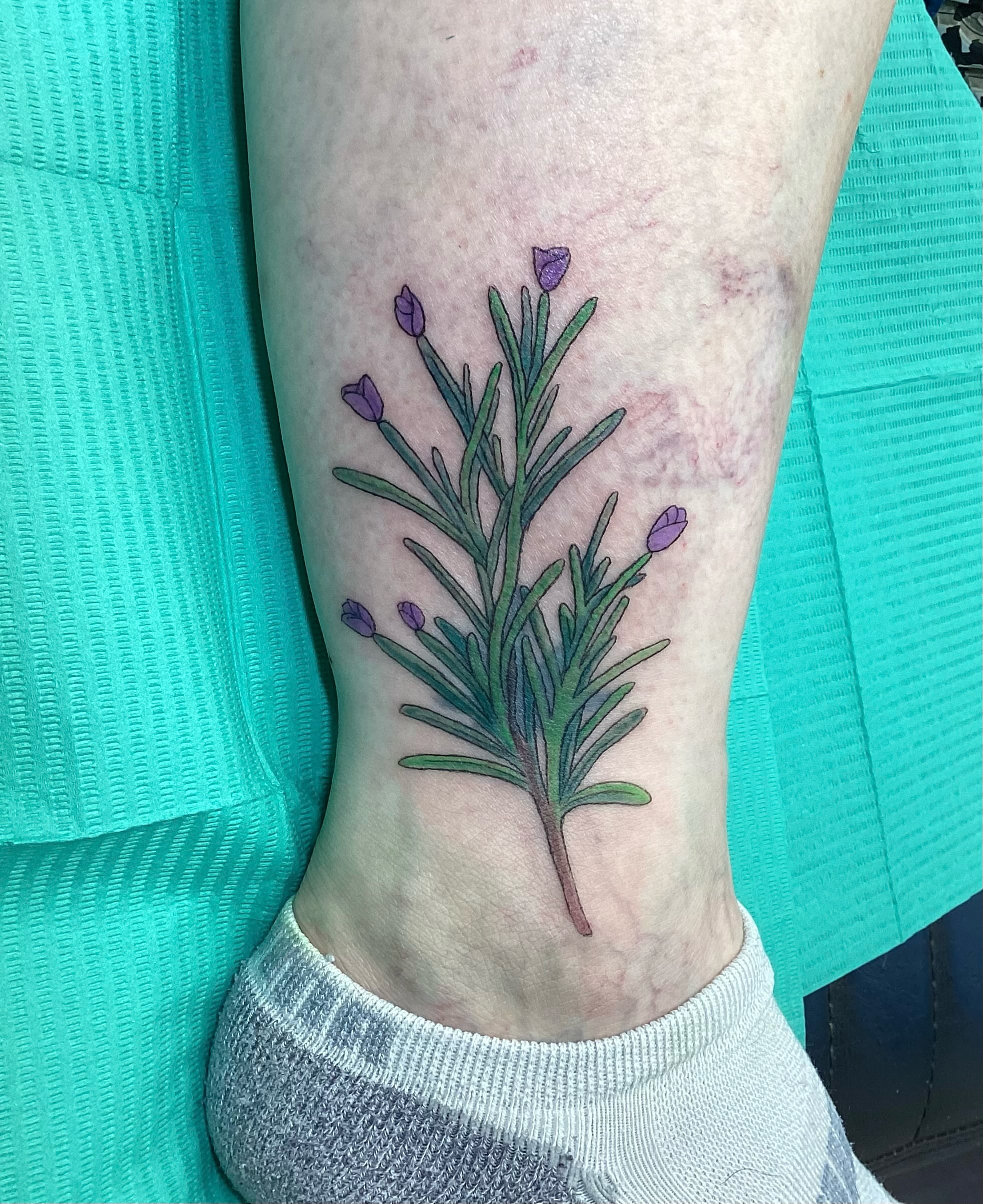 Rosemary plant realism tattoo on the calf by Amanda Plavan