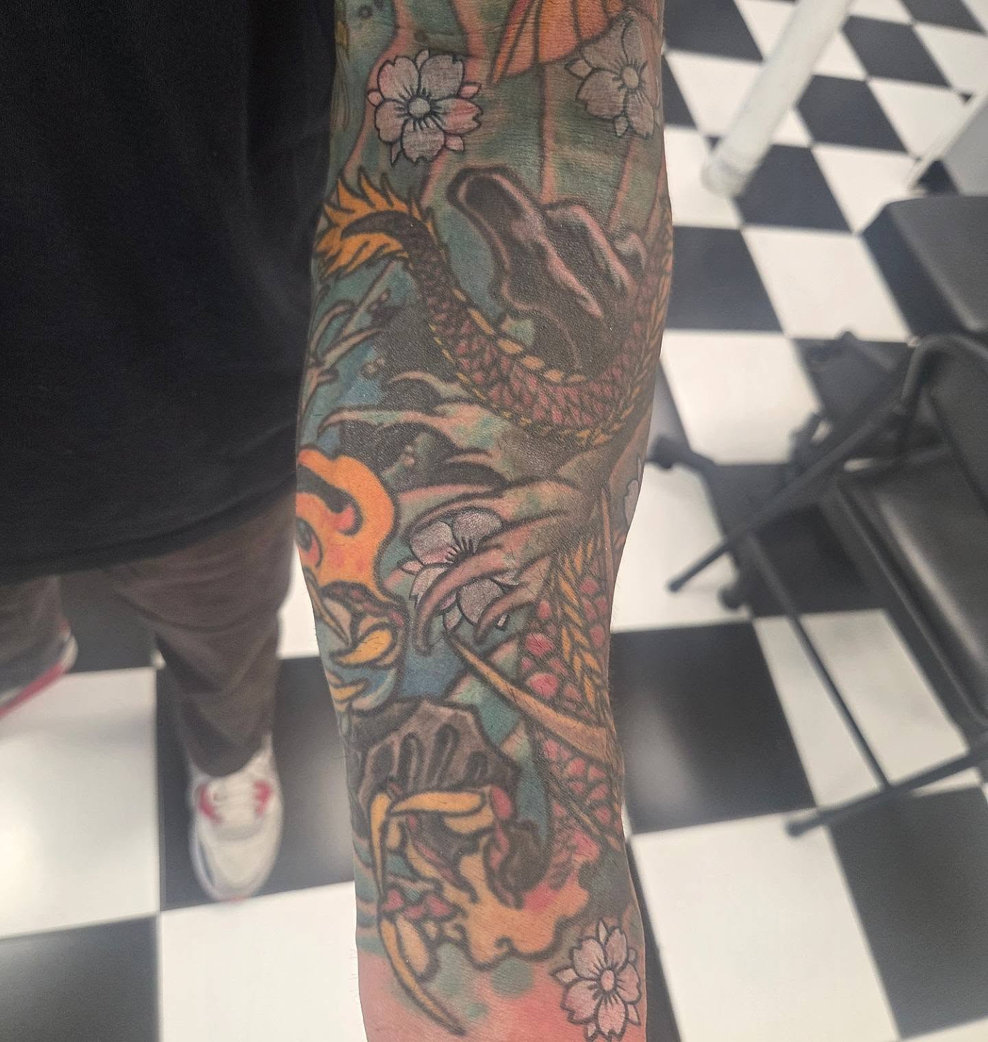 Dragon and flowers japanese irezumi tattoo on the forearm by Molly DeSmedt
