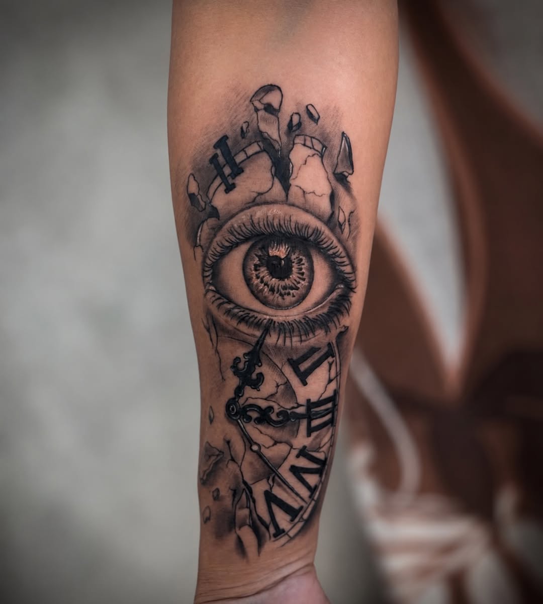 Eye and clock surrealism tattoo on the forearm by Mauricio gois