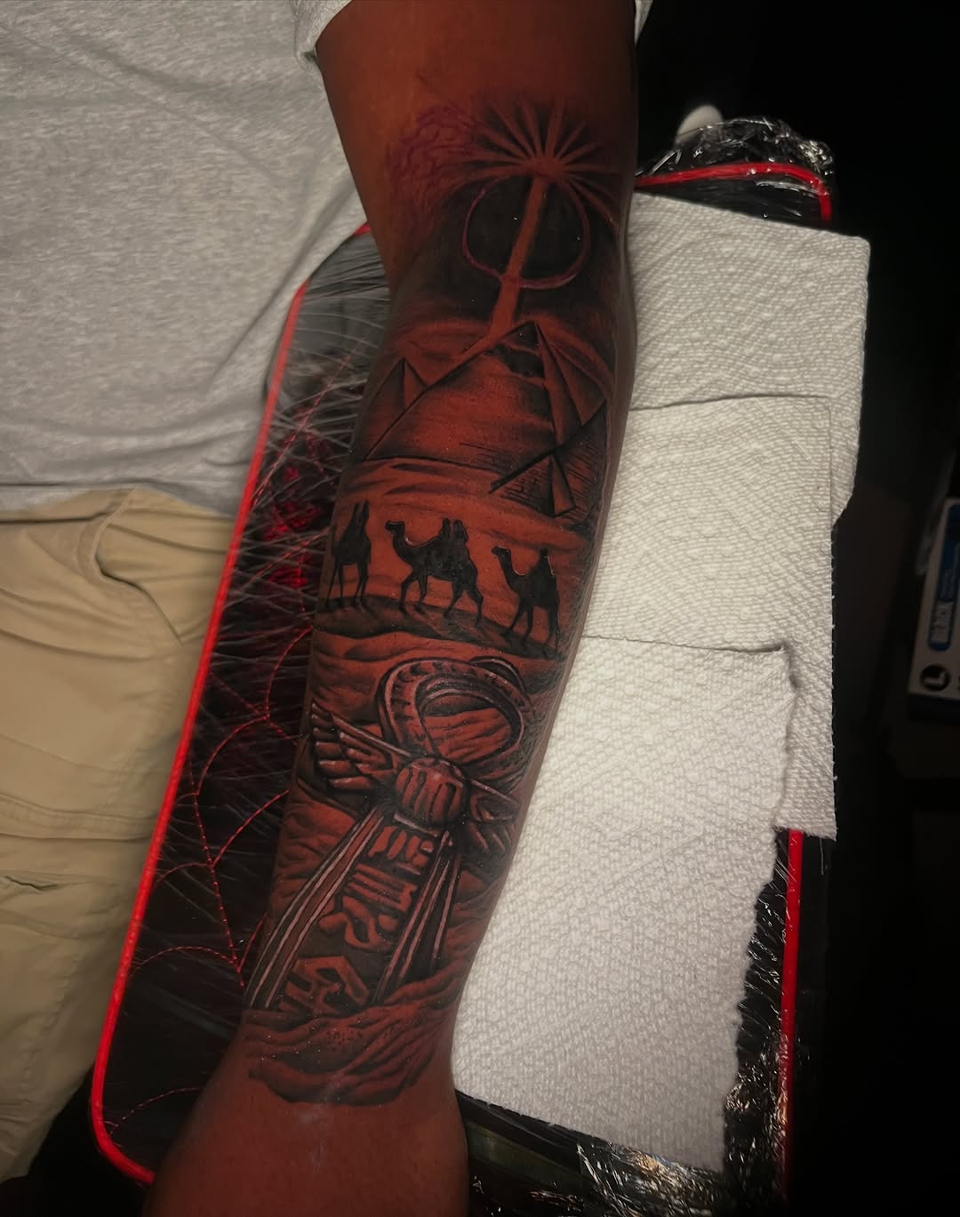 Egyptian scene with pyramids and ankh tattoo on the forearm by red, Charlotte, North Carolina