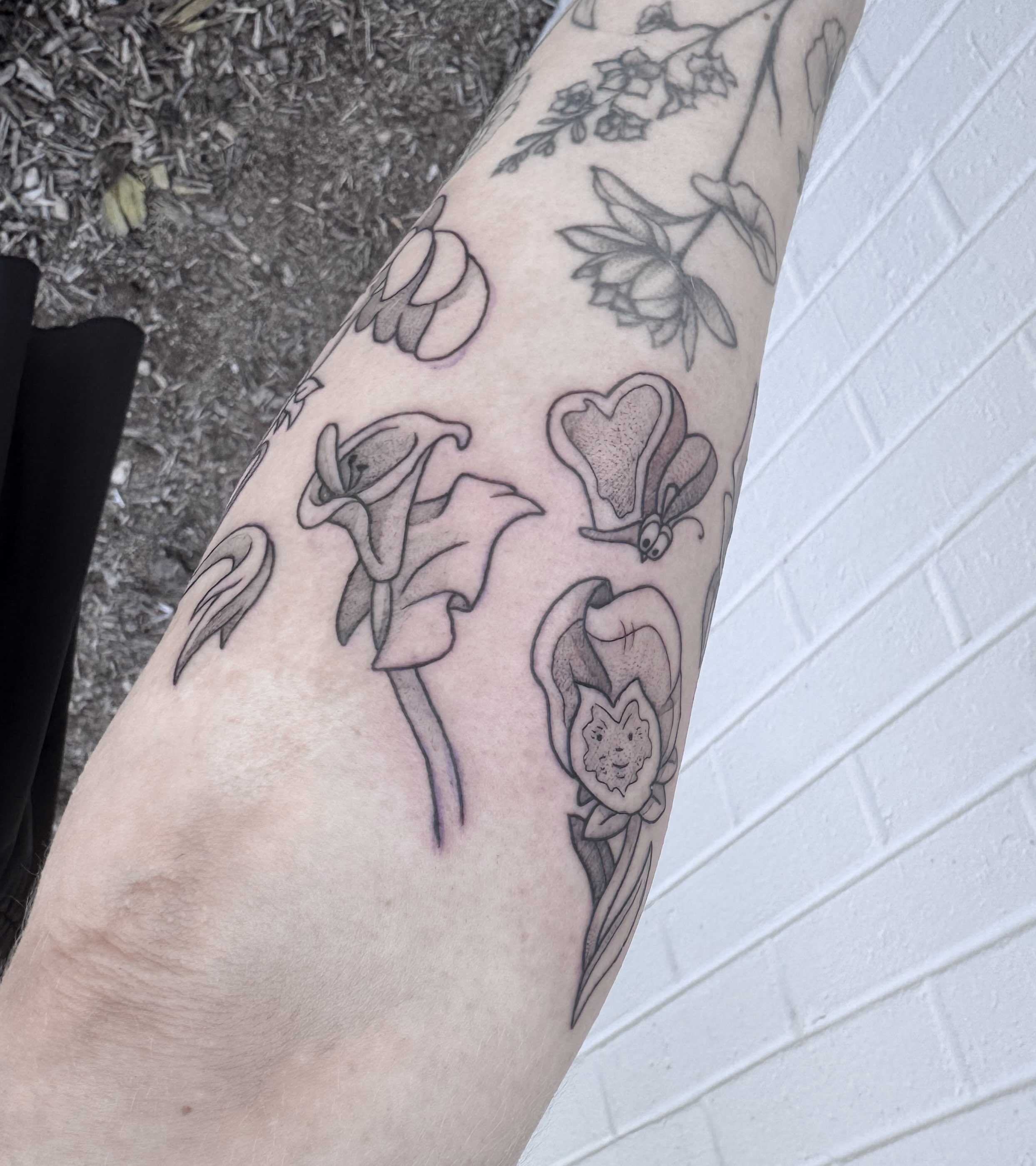 Flowers black and grey tattoo on the forearm by Audrey Kacel, Holland, Michigan