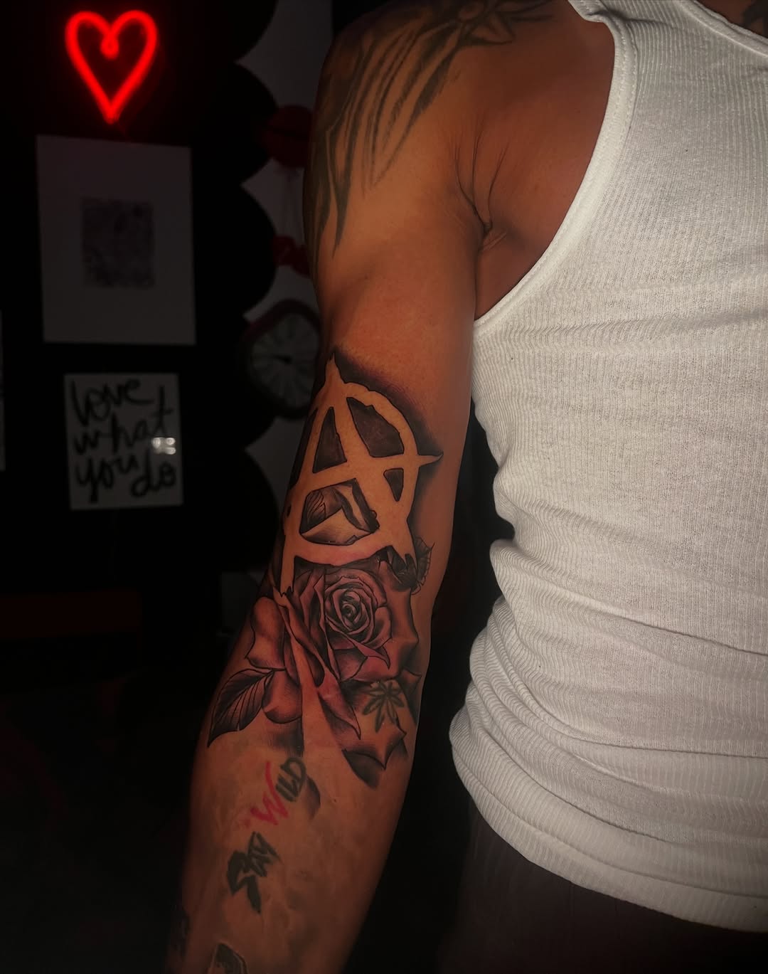Anarchy symbol and rose tattoo on the forearm by red, Charlotte, North Carolina