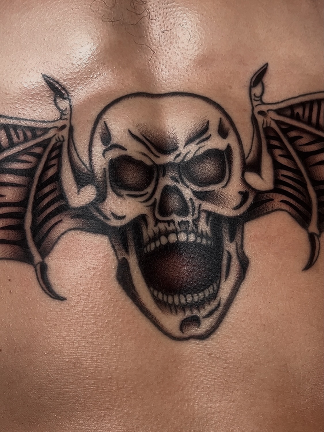Skull black and grey tattoo on the chest by Las Vegas Tattoo Artist