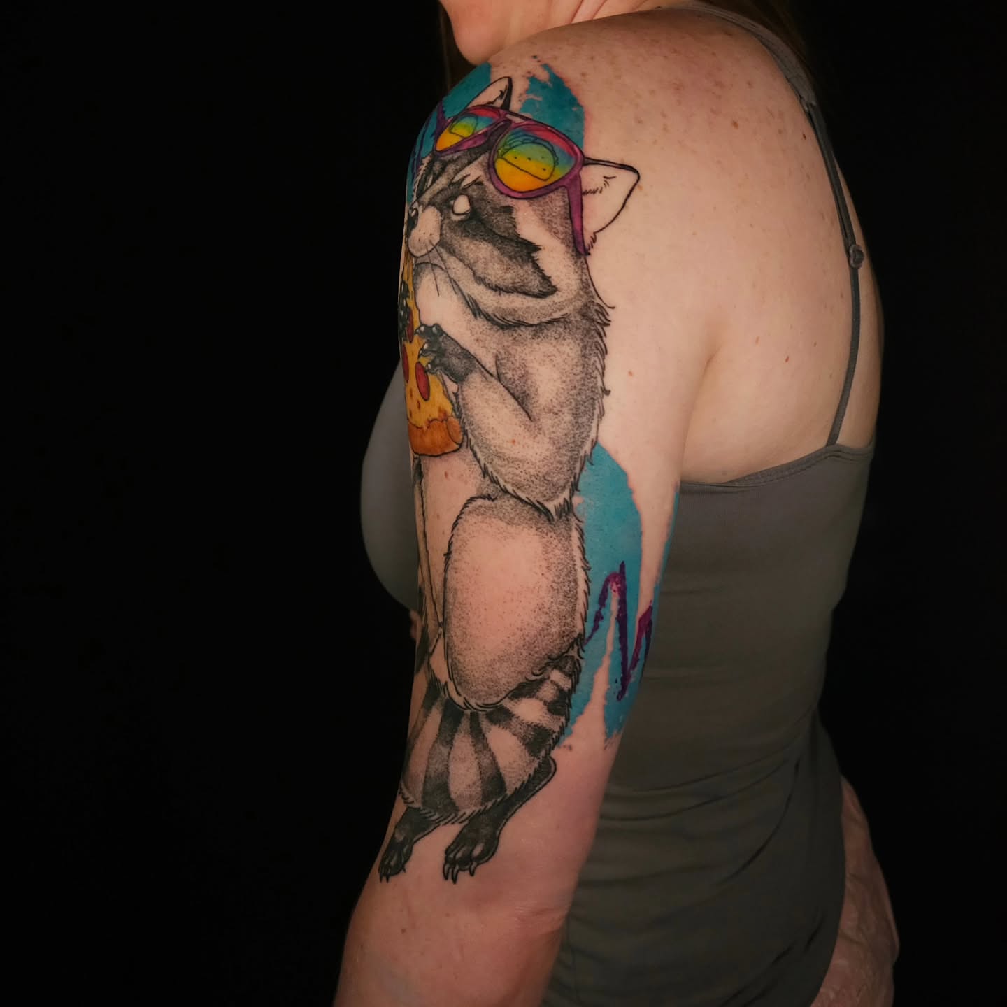 Raccoon wearing sunglasses realism tattoo on the upper arm by Eva the Tattoo Fartist in Seattle, WA, Seattle, Washington