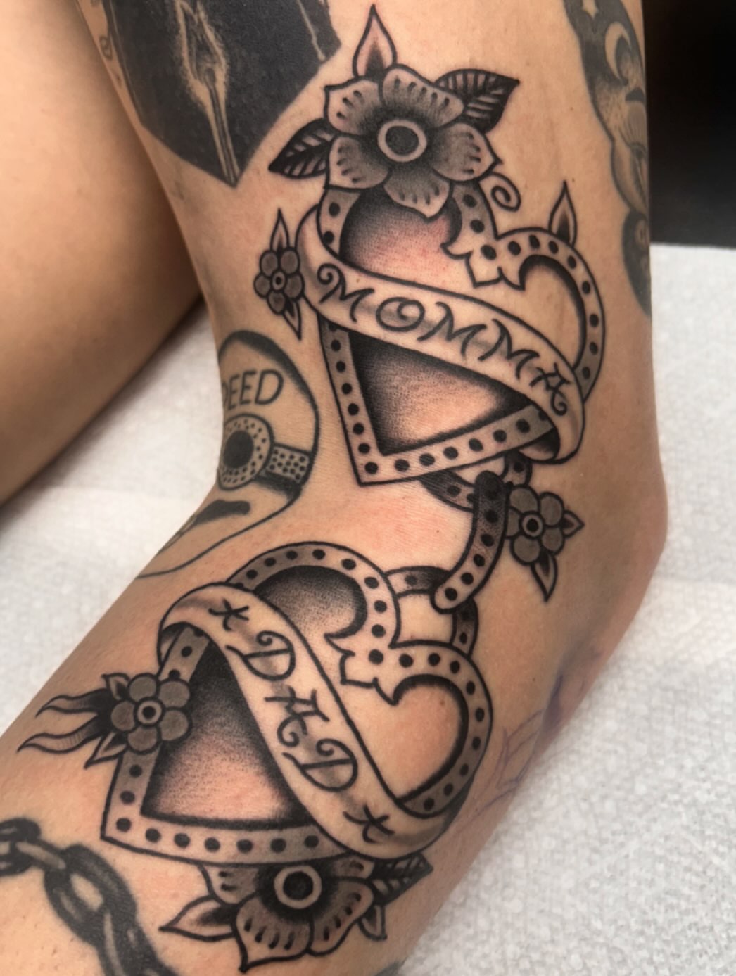 Film strip and heart black and grey tattoo on the forearm by Tiffany Vargas