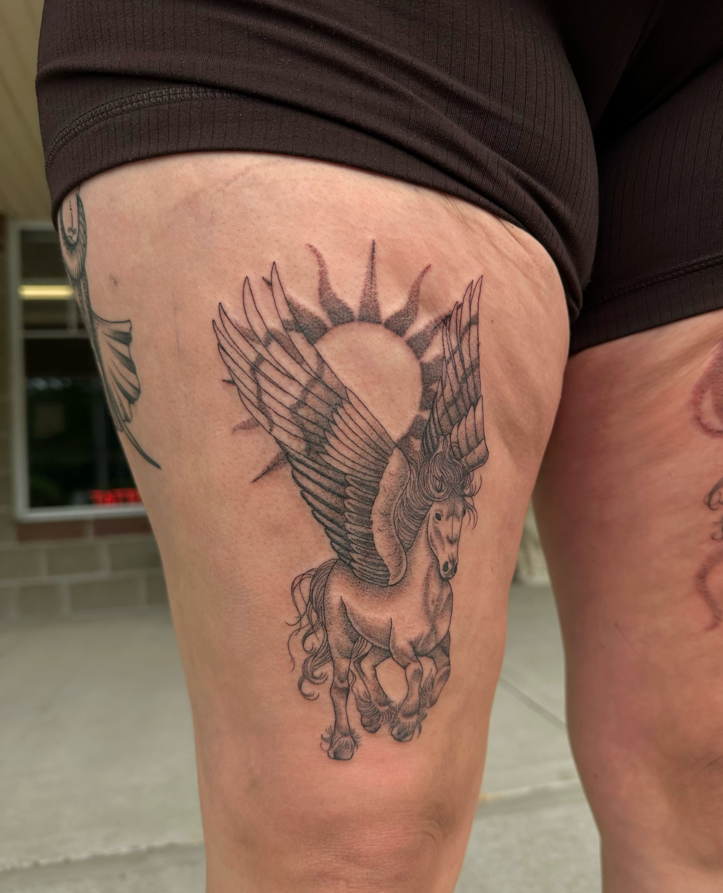 Pegasus black and grey tattoo on the thigh by J Valentin