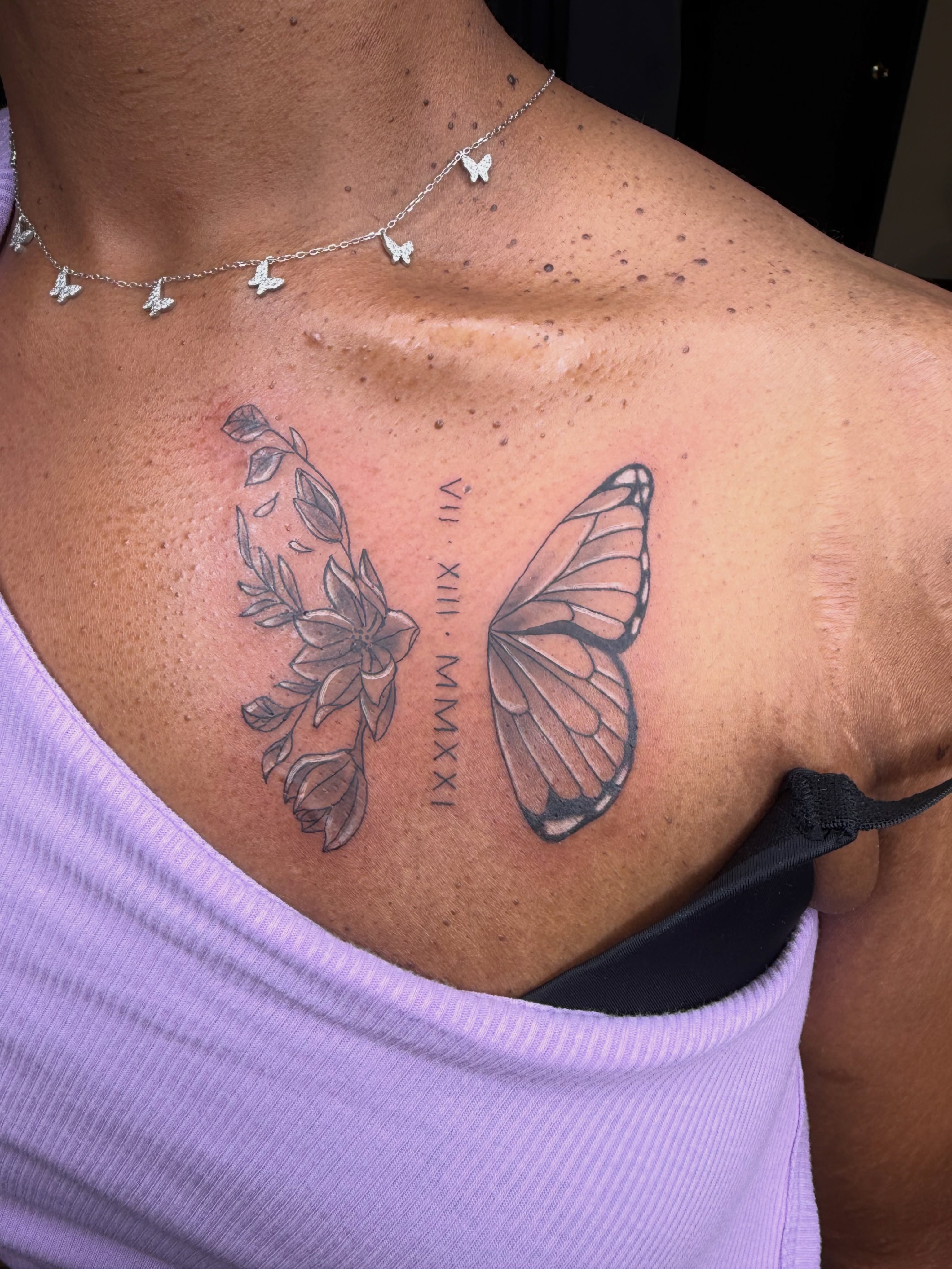 Butterfly and floral black and grey tattoo on the chest by Rain David