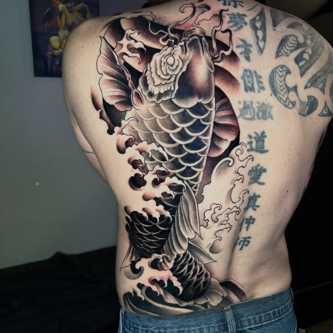 Koi fish and waves japanese irezumi tattoo on the back by Eddie Wolfe