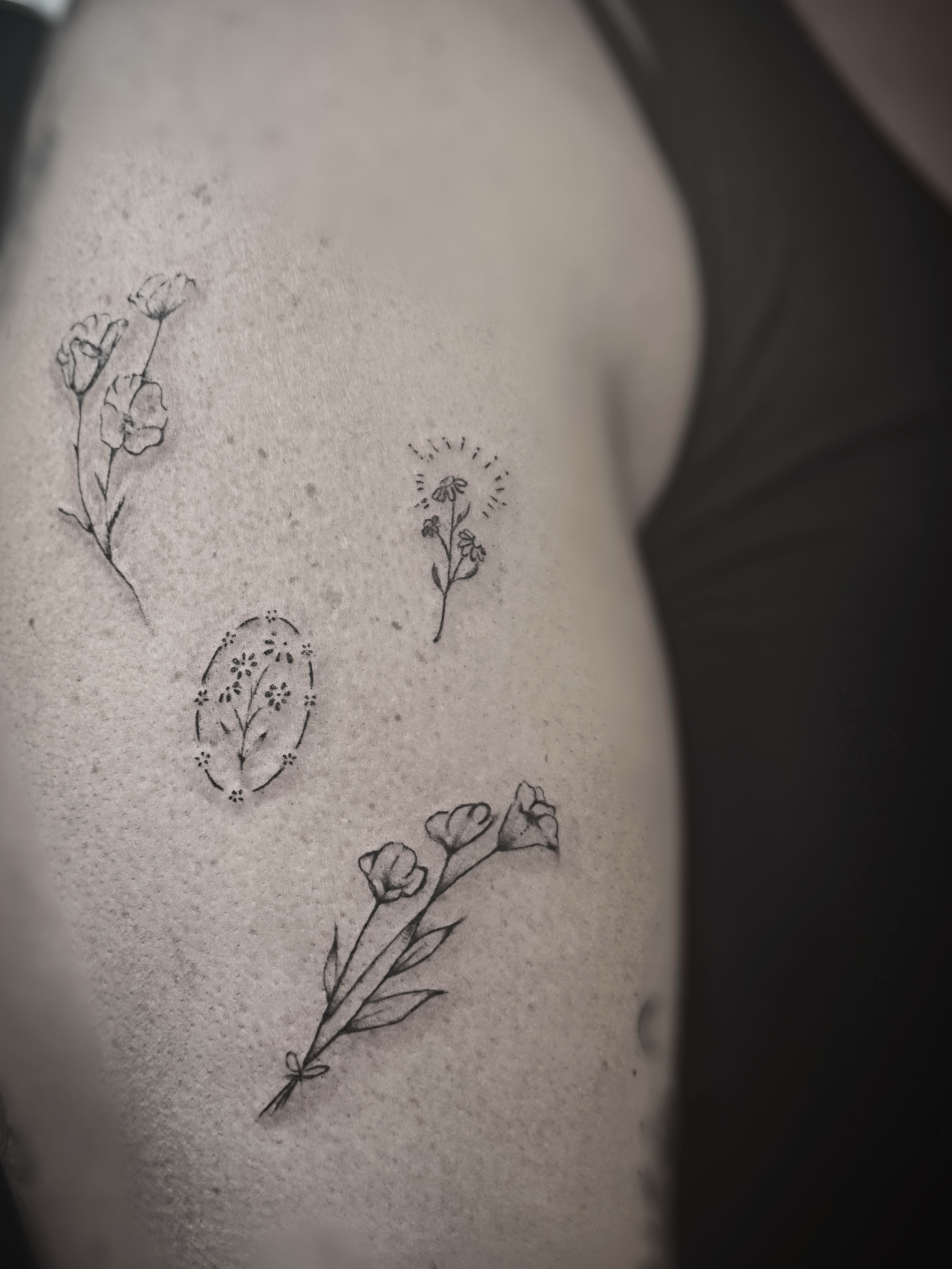 Floral arrangement fine line tattoo on the shoulder by Meagan, Charlotte, North Carolina