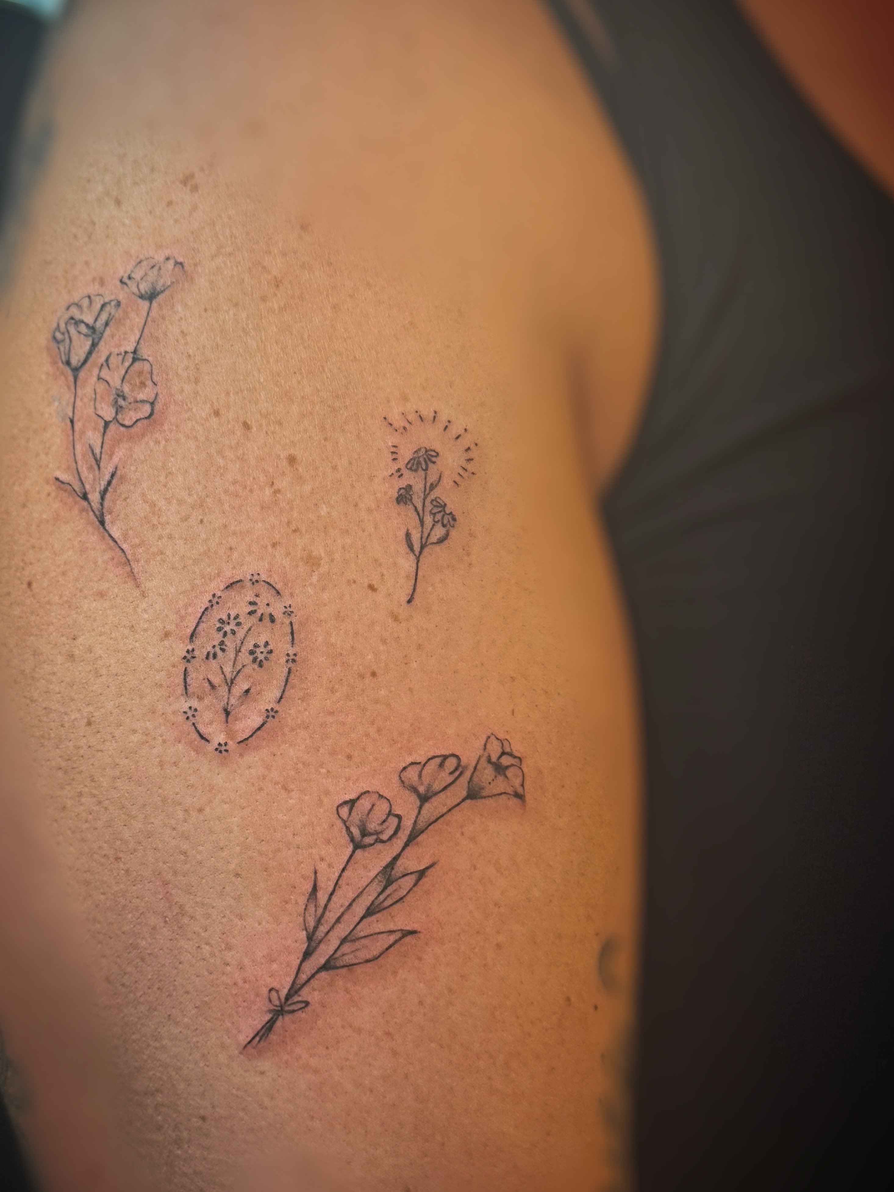 Floral arrangement black and grey tattoo on the shoulder by Meagan, Charlotte, North Carolina