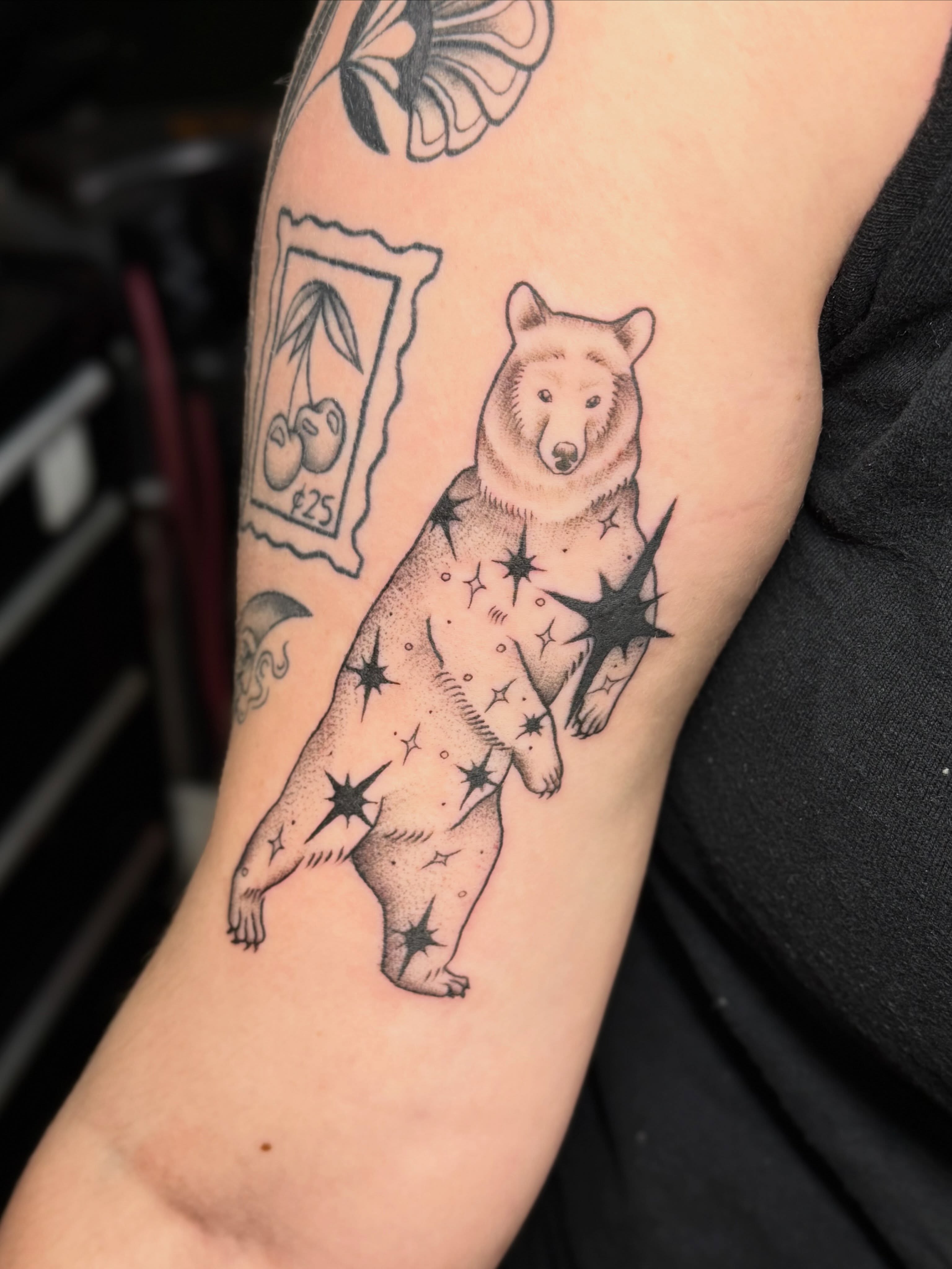 Bear with stars dotwork tattoo on the forearm by Bri ⚡️✨