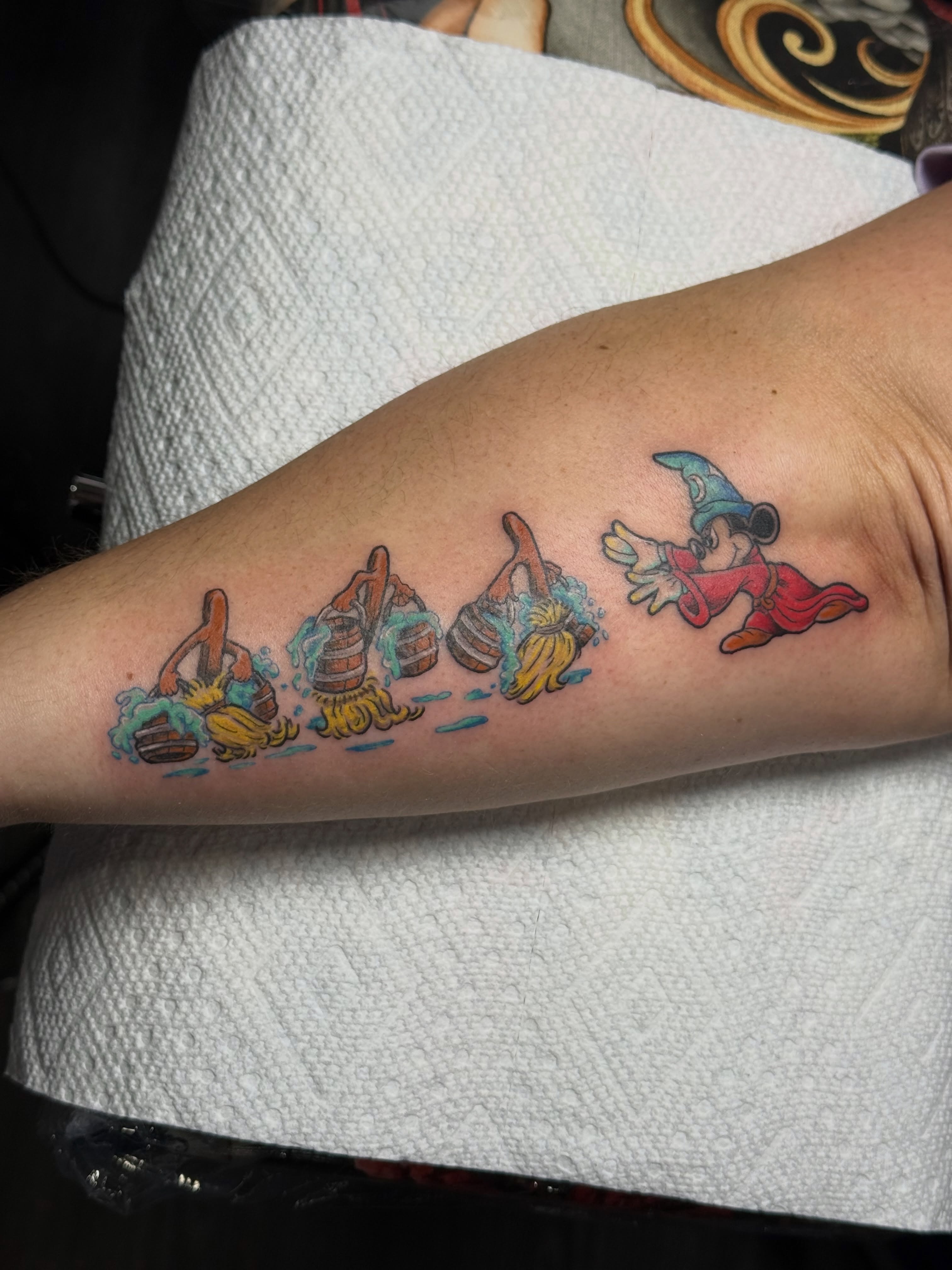 Magic scene new school tattoo on the forearm by Camryn Justice