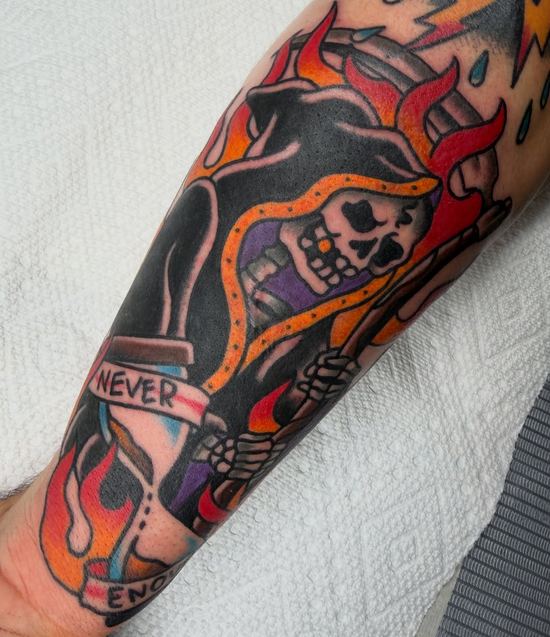 Skull and flame American traditional tattoo on the forearm by April Morris ⚔️ Tattoo Goblin