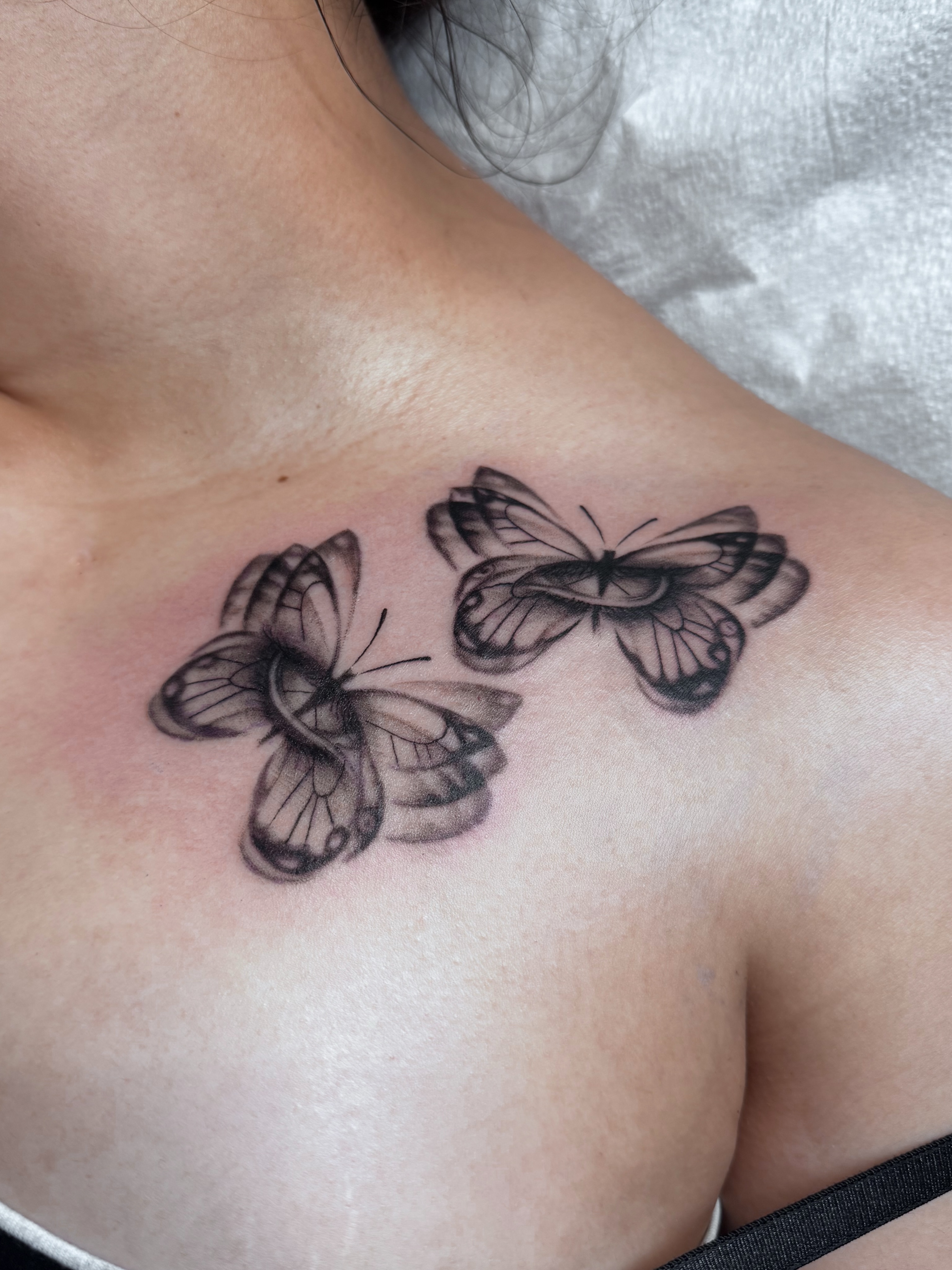 Butterflies black and grey tattoo on the chest by @nudylicioustattoos