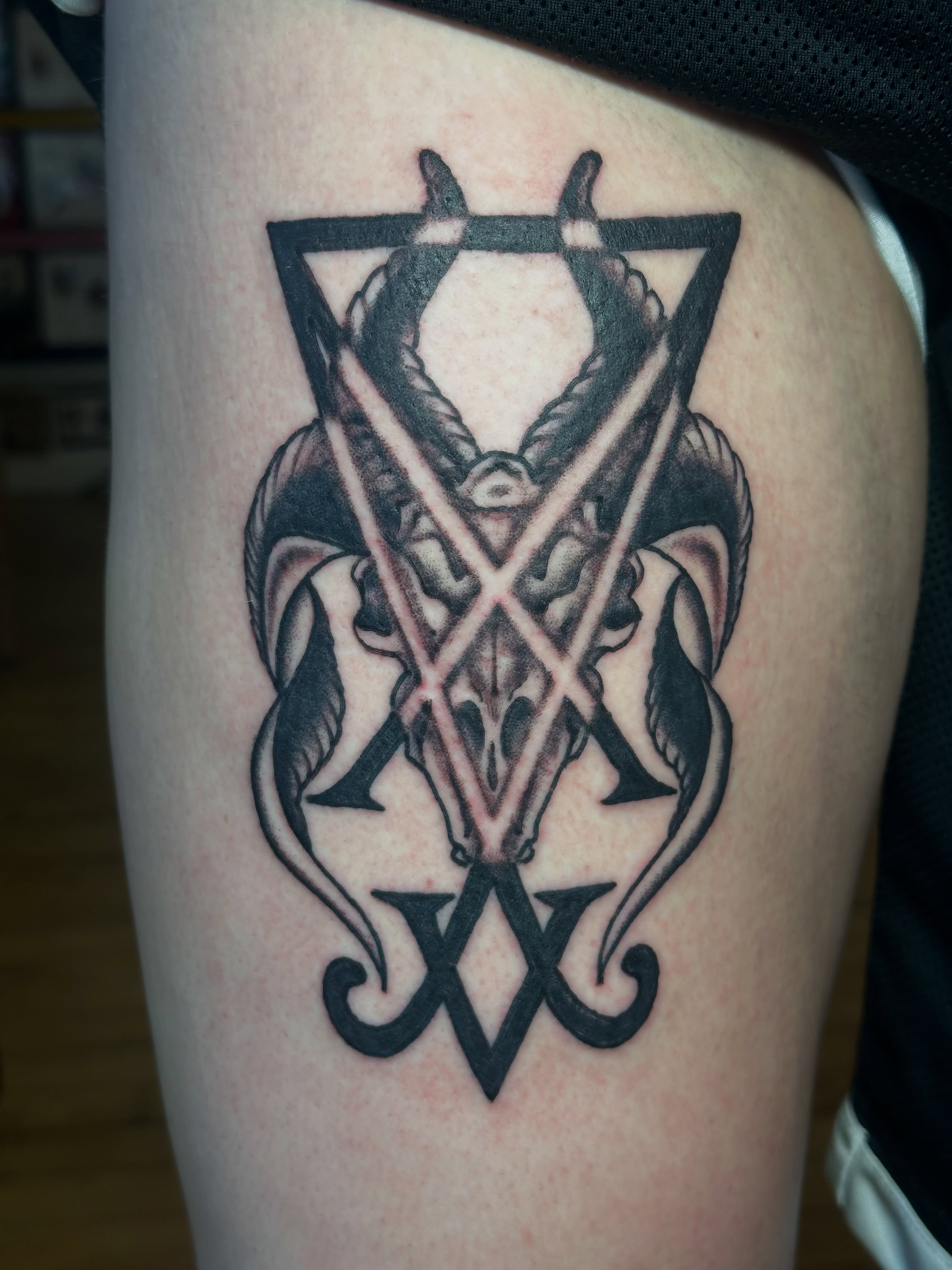 Pentagram with goat skull geometric tattoo on the thigh by Providence Tattooer